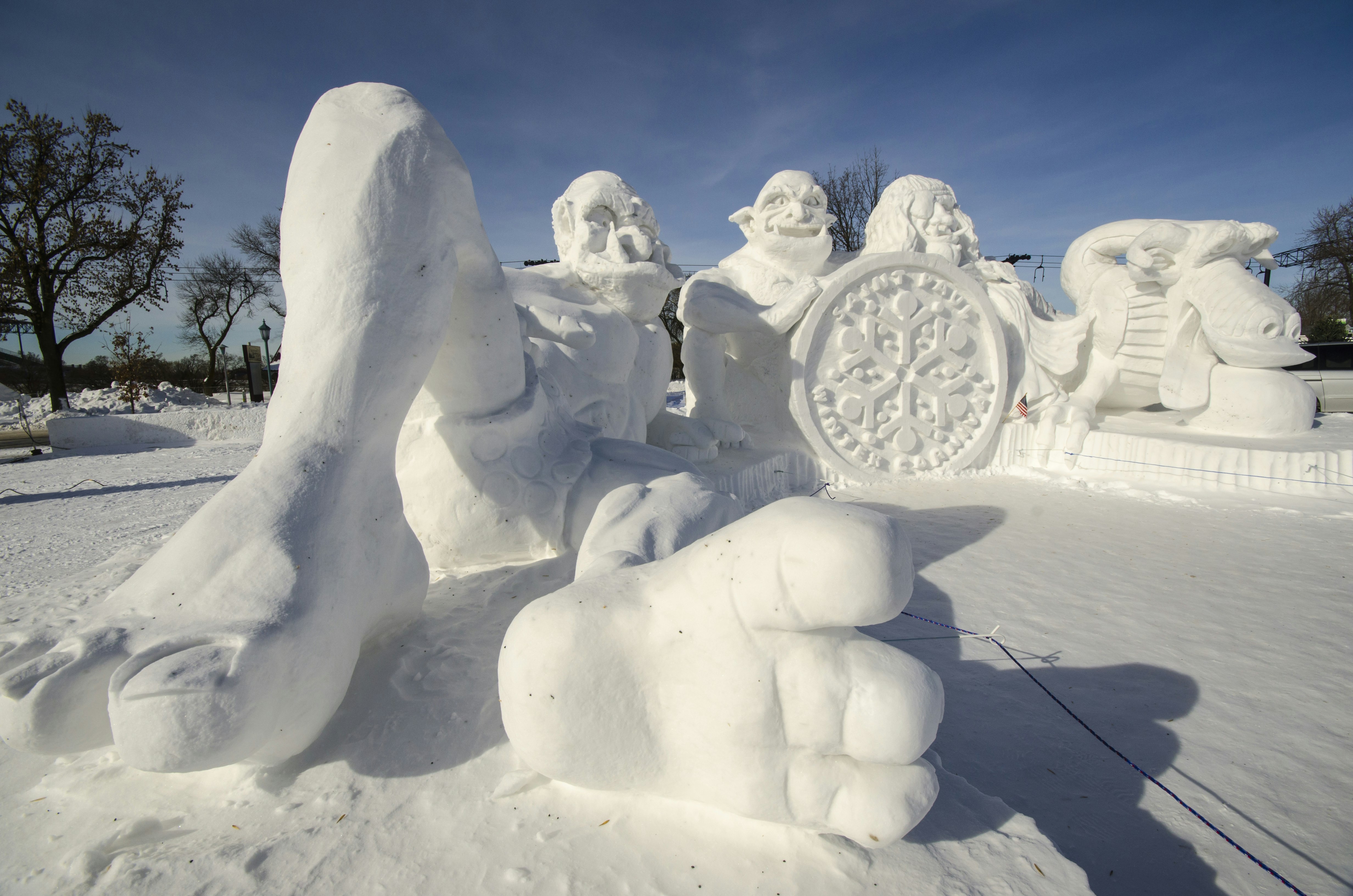 Large snow sculptures in the likeness of ogres and a dragon are on display at the St. Paul Winter Carnival.