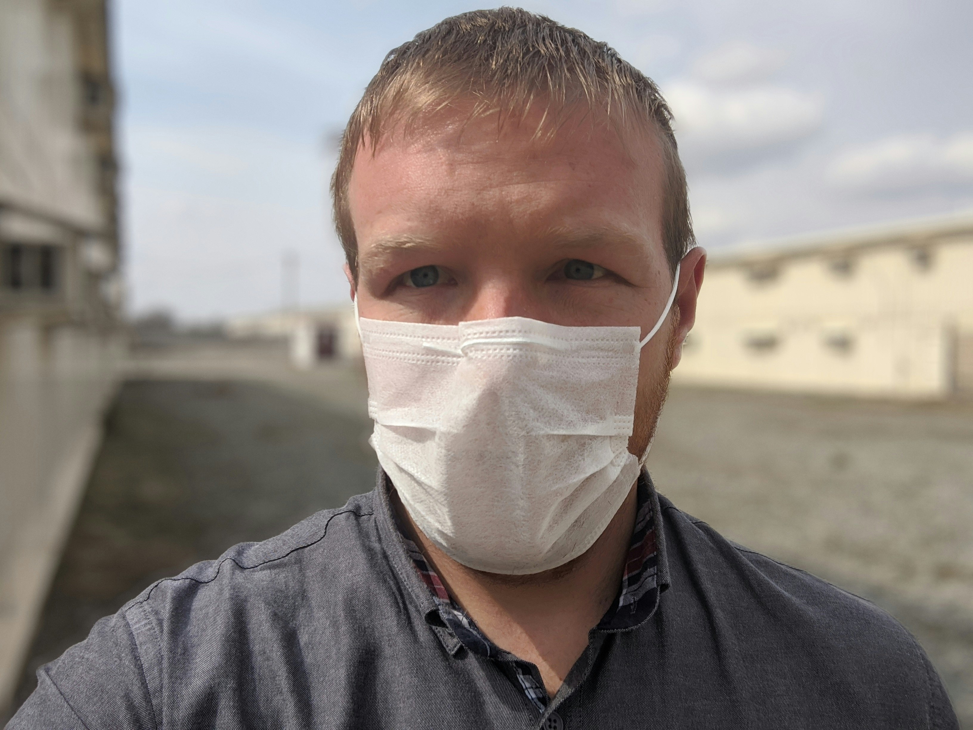 Stephen Lioy, wearing a face mask in the prison-like yard of a former military facility in Bishkek. 