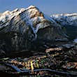 Looking down from the summit of a mountain at a town illuminated at dusk in winter at Banff and Lake Louise