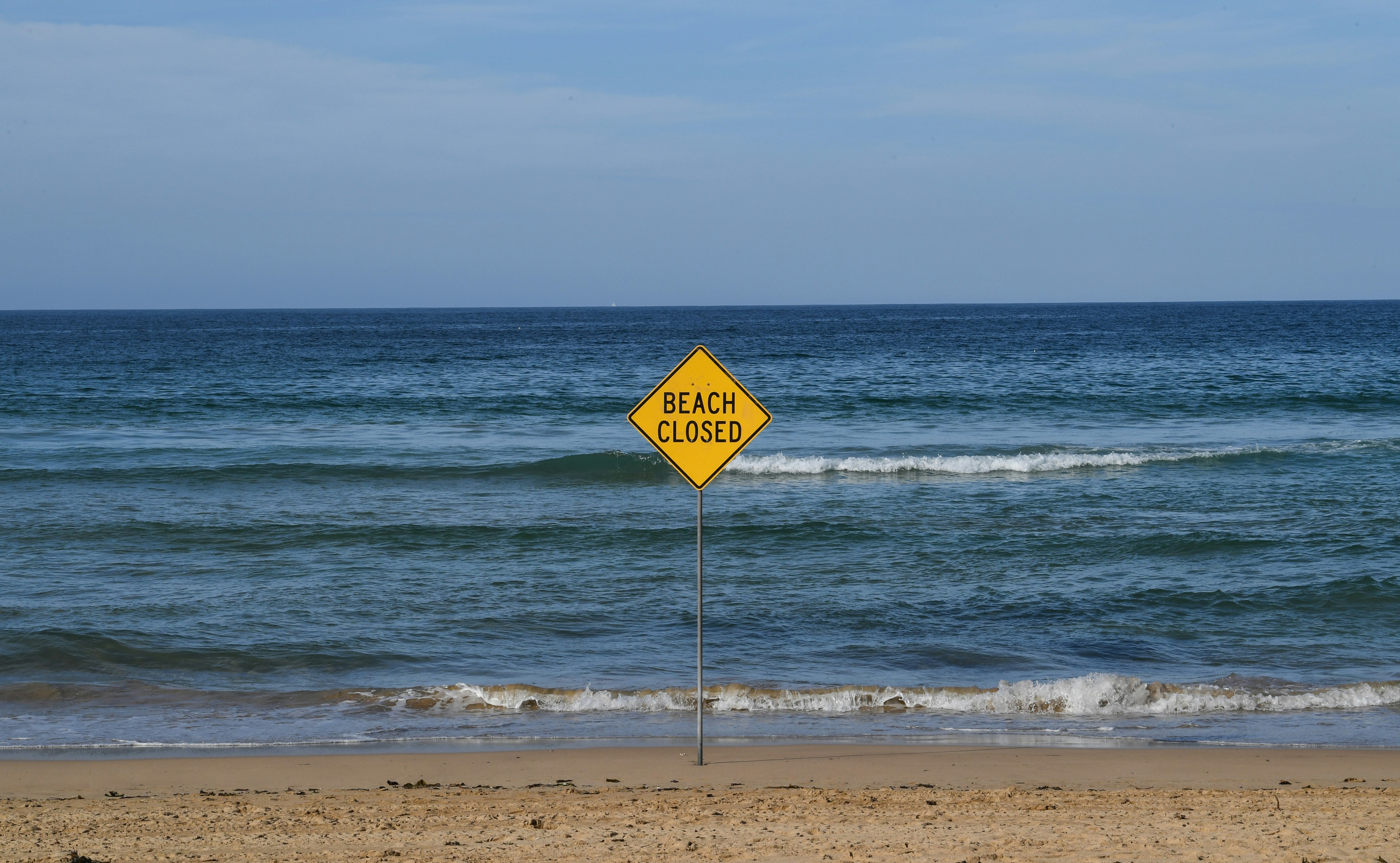 A beach closed sign on Manly Beach on March 22