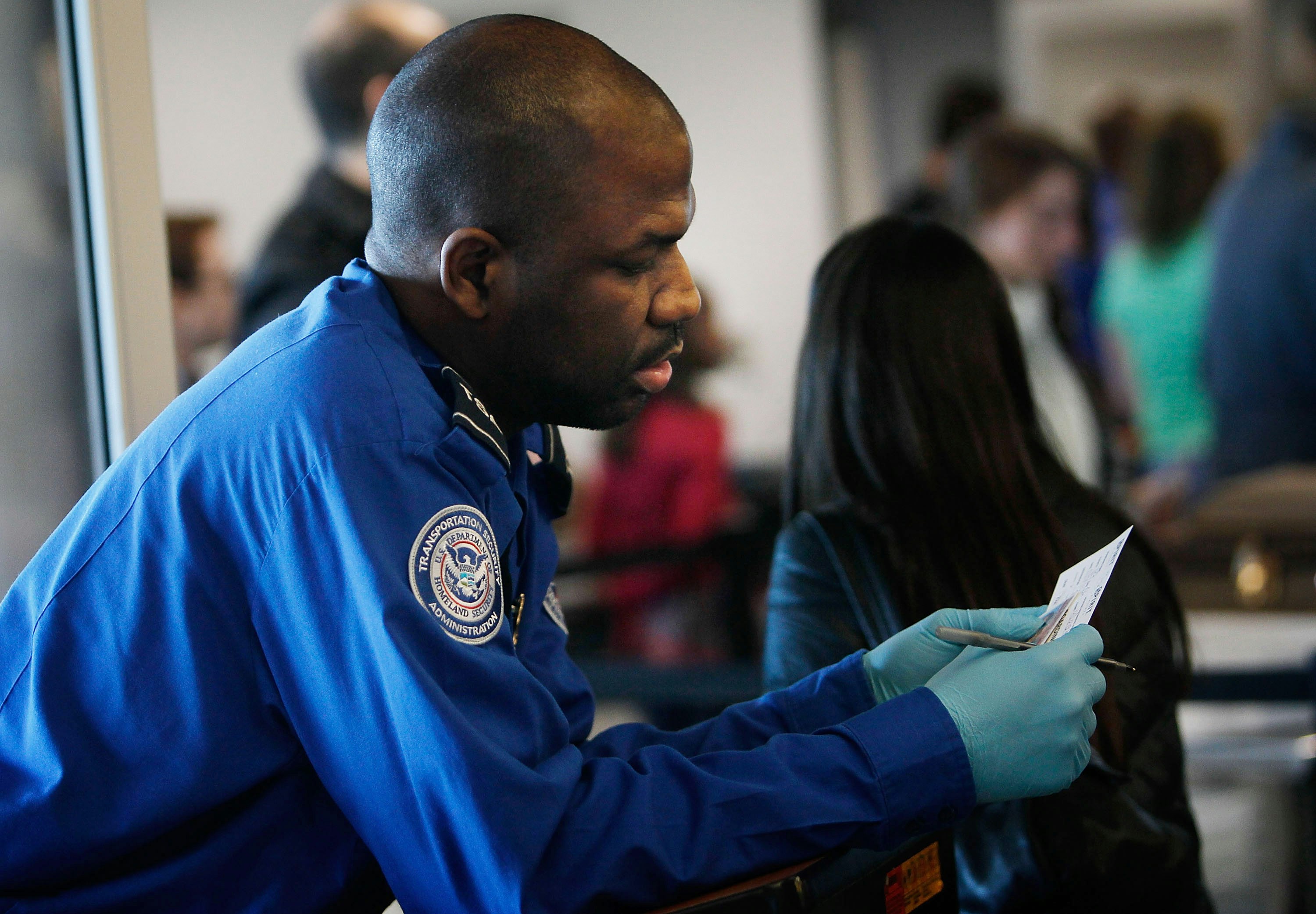 TSA agent checks identification card