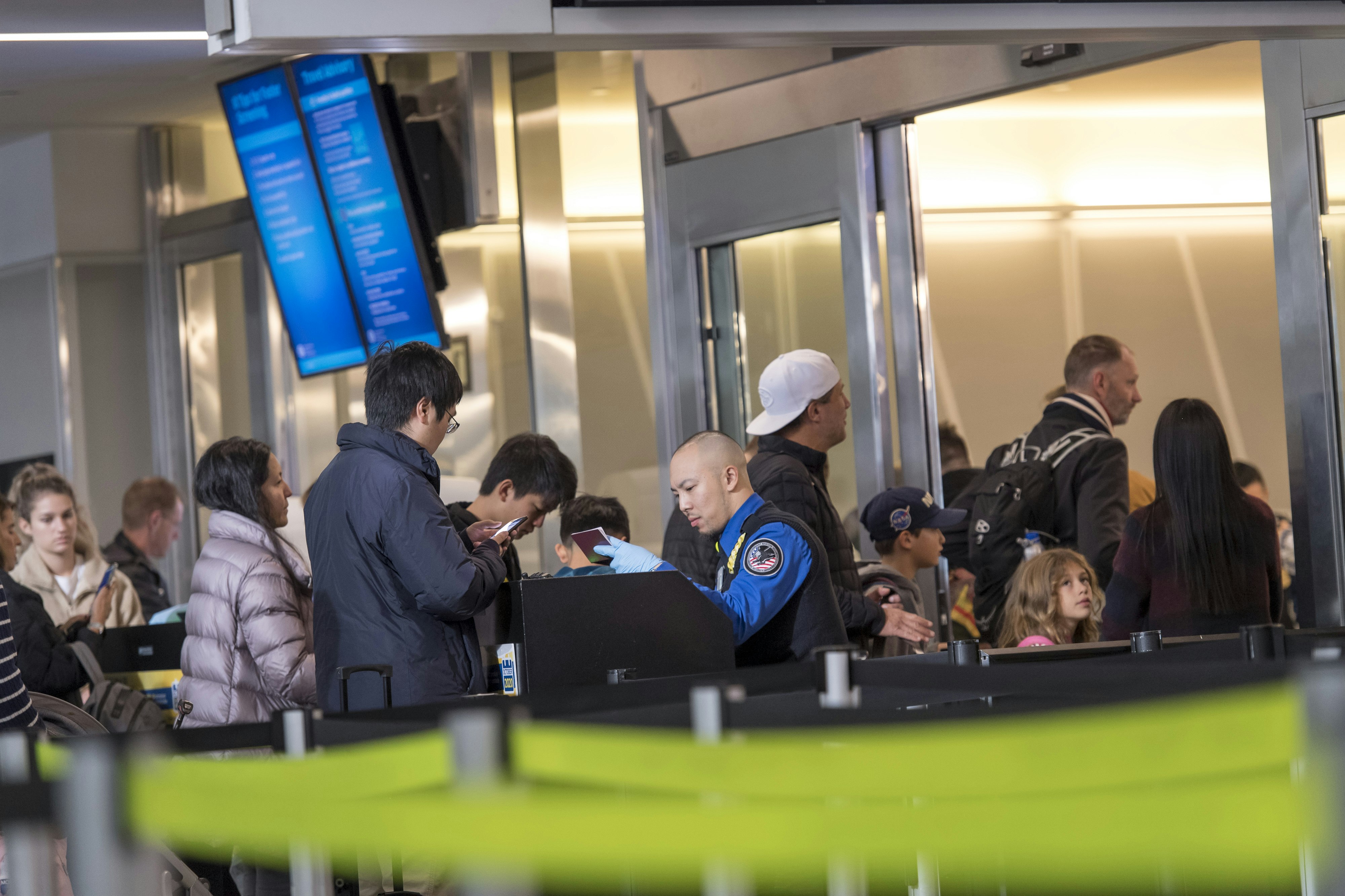 A Transportation Security Administration (TSA) agent views a traveler's passport at a checkpoint at San Francisco International Airport in San Francisco, California, U.S.