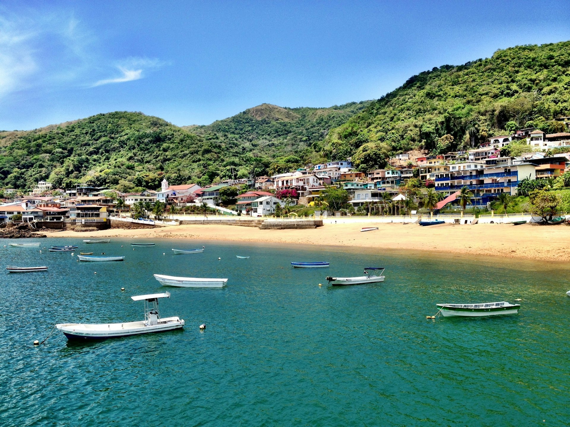 A collection of small boats are moored off the island shore of Taboga in Panama; perfect weekend Panama