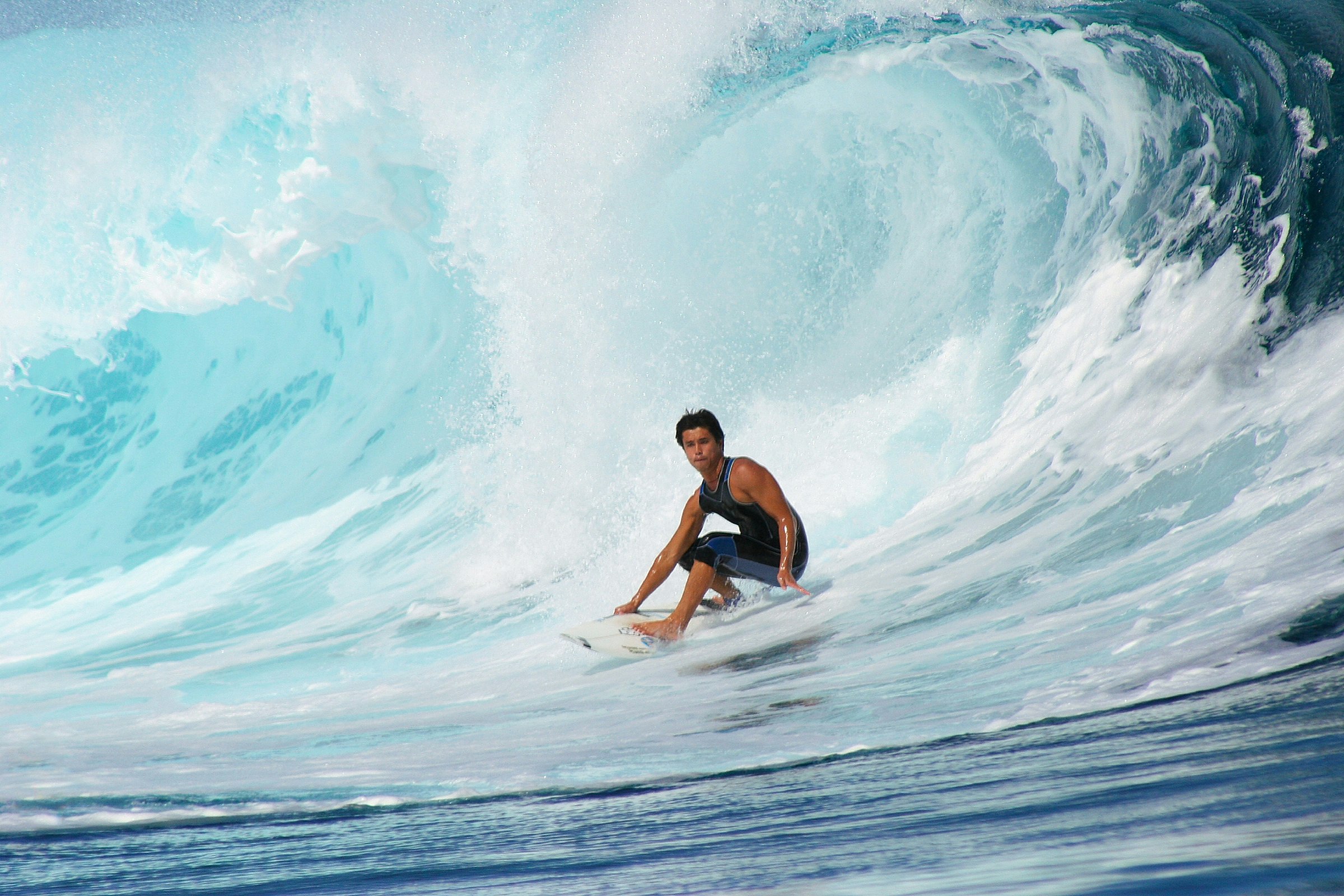 Close-up of boy surfing in big wave at Teahuopoo,Tahiti. 