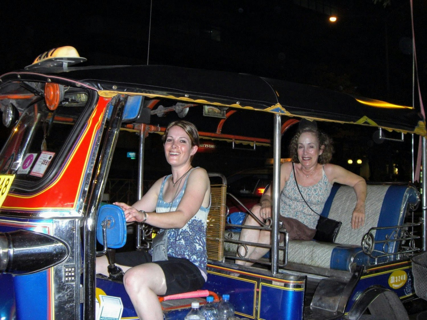 Maxine and Laura DeCook traveling in a tuk tuk in Thailand