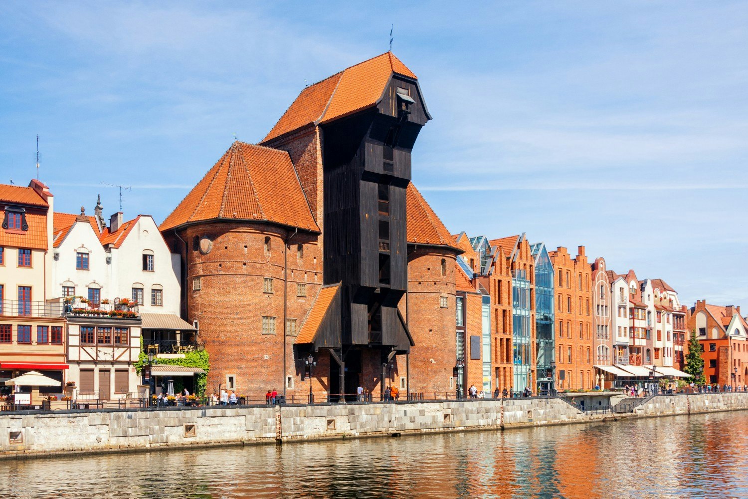 Scenic view of the riverside with medieval Port Crane (Zuraw) and historic buildings on the embankment of the Motlawa River, Gdansk, Poland.