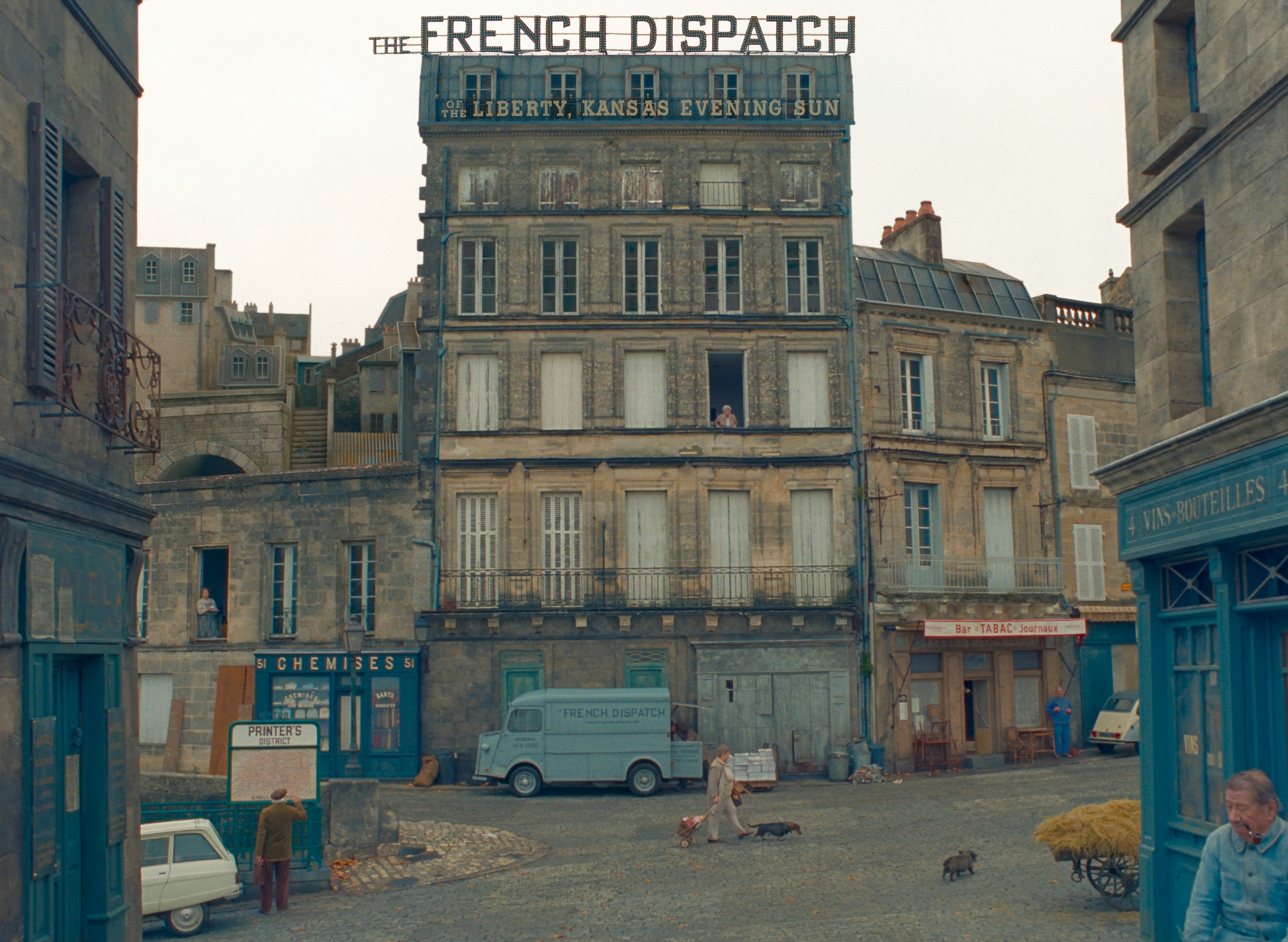 A still from the film The French Dispatch which depicts an exterior shot of a newspaper office