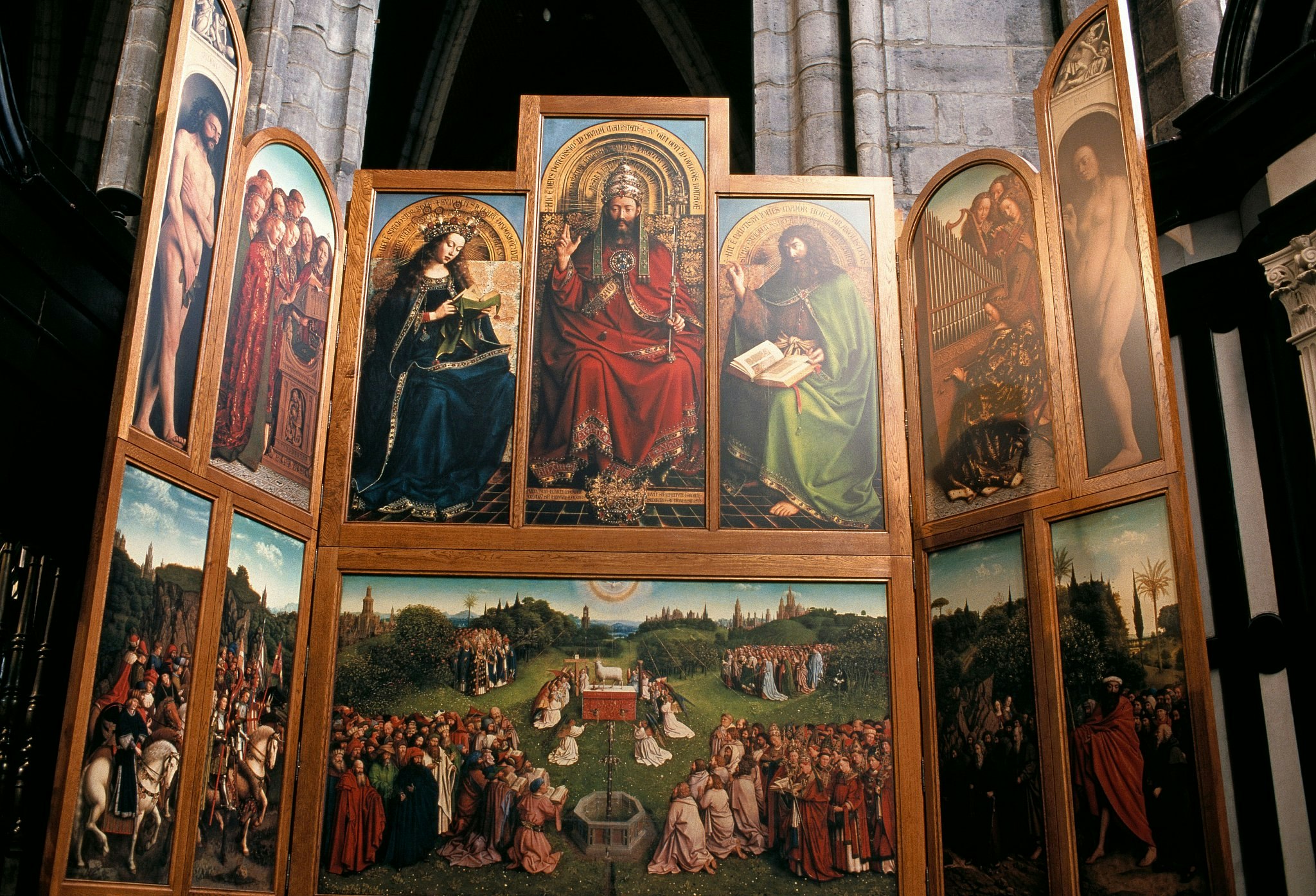 The Ghent Altarpiece, an enormous painting with a large central section and on either side two “wing” sections on hinges, on display in St Bavo Cathedral.