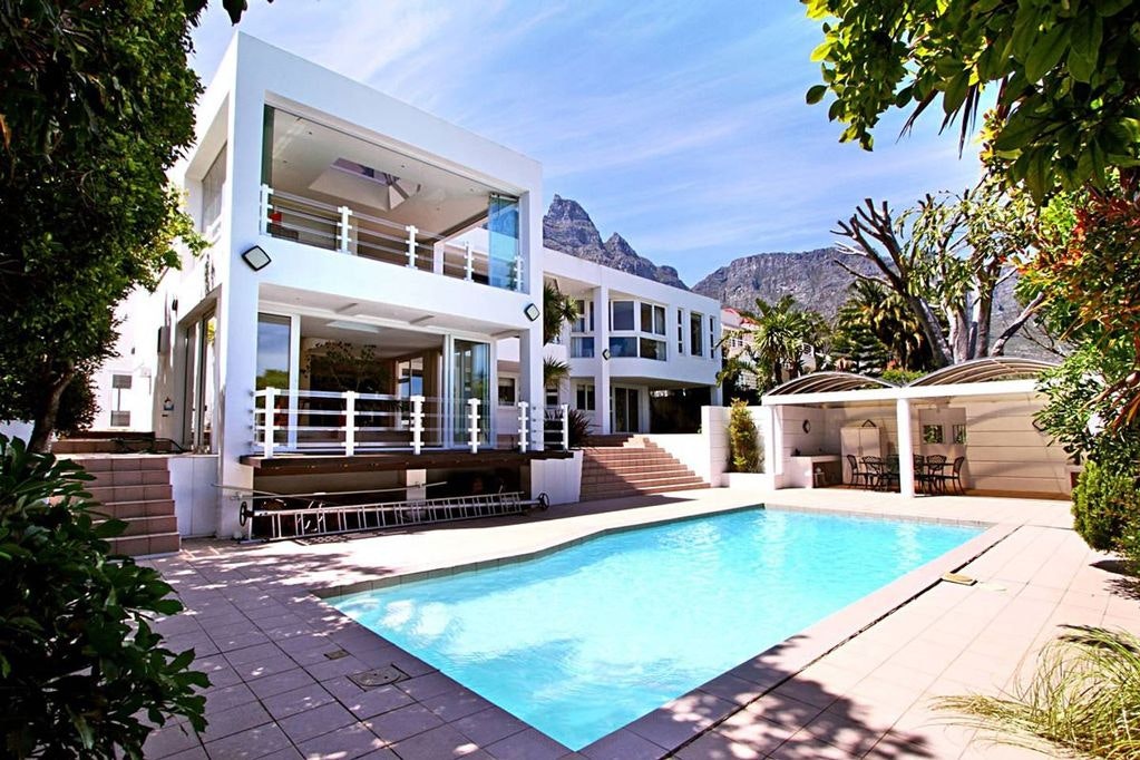 View of a villa in Cape Town flanked by mountains and a pool
