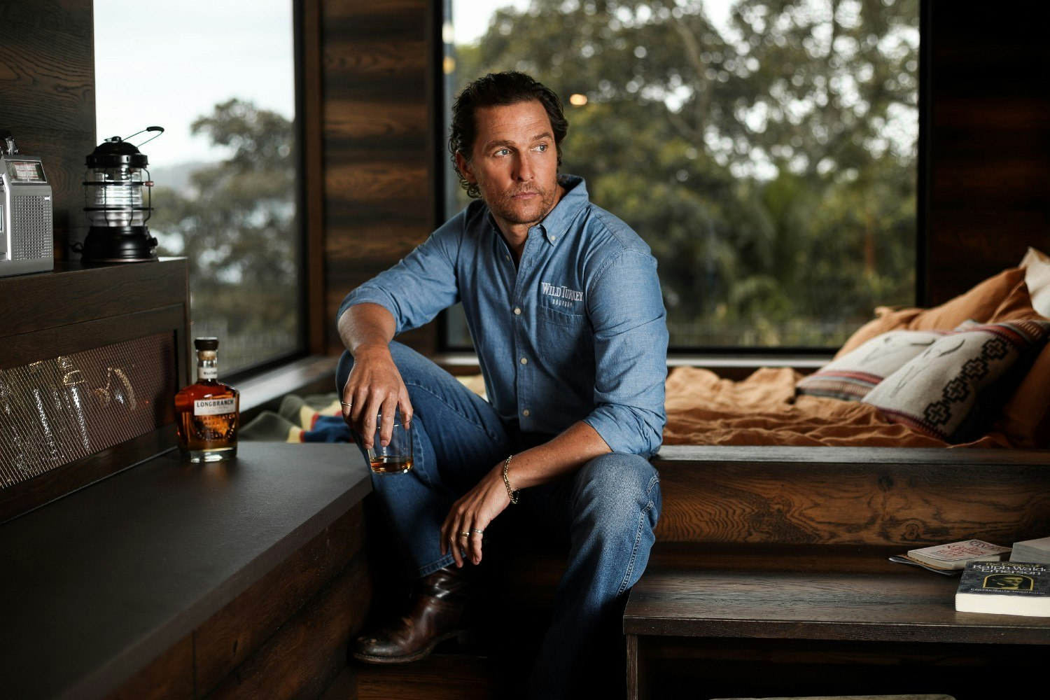 Matthew McConaughey kneeling inside the eco cabin he helped design