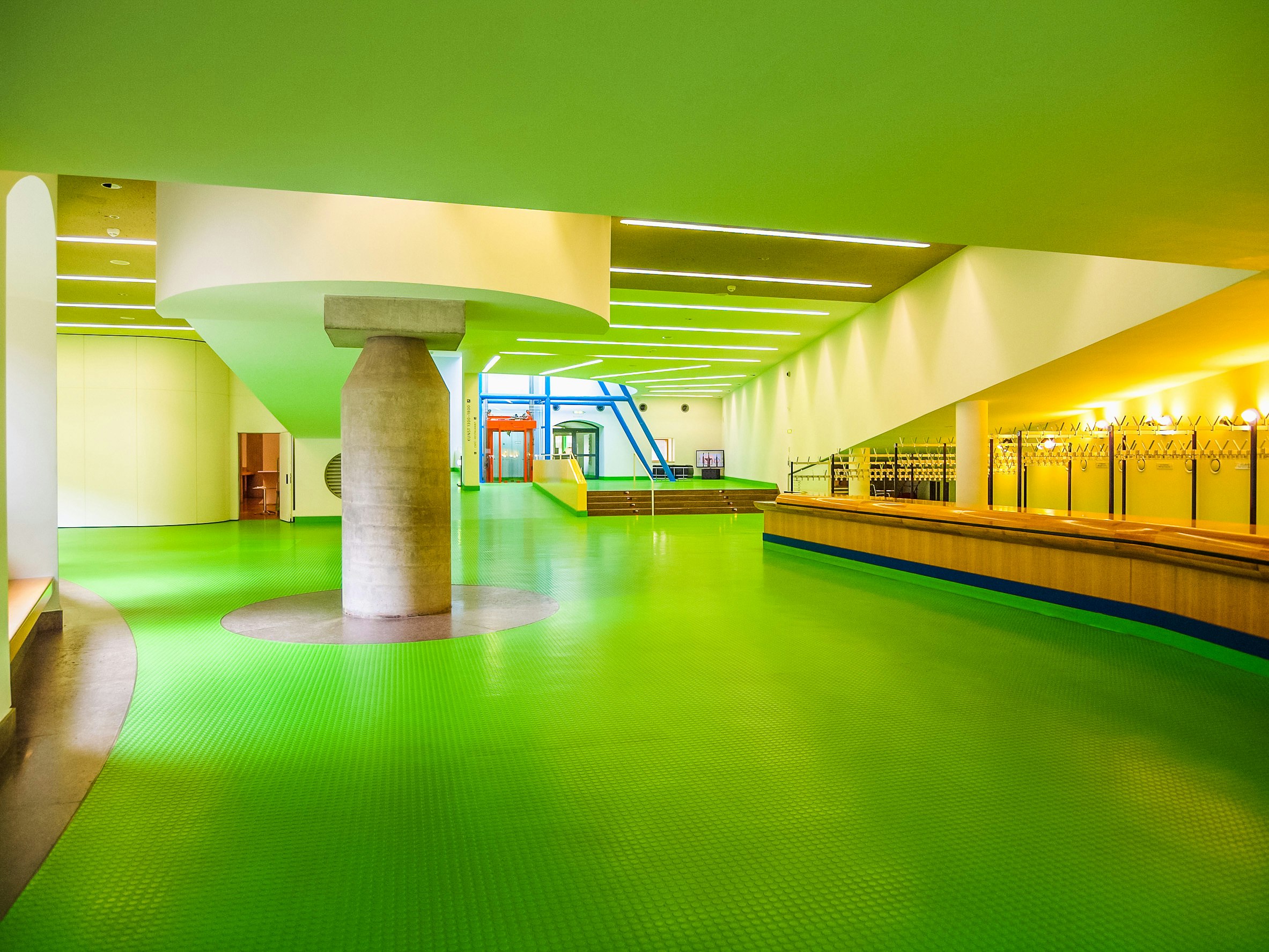 A shot of the inside of the Staatsgalerie, Stuttgart, Germany. The floor is green and support beam is visible in the middle of the photo.
