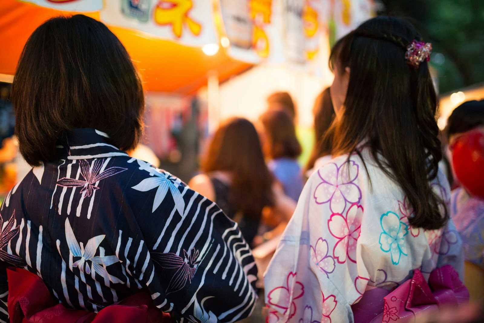 A pair of women dressed in yukata (cotton kimono) at a summer festival in Tokyo