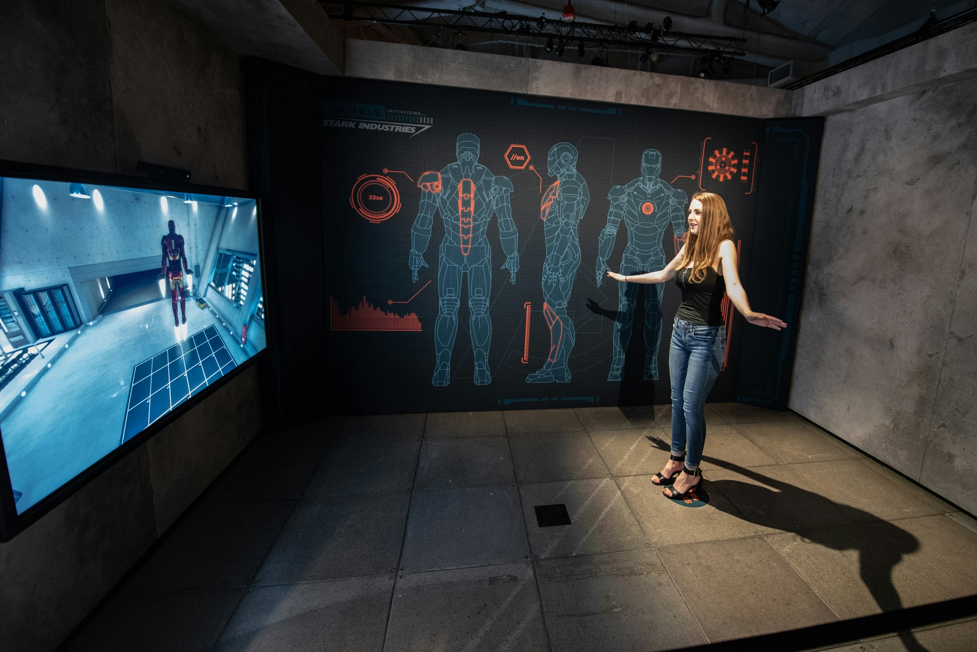 A young woman tests out an Iron Man augmented reality experience