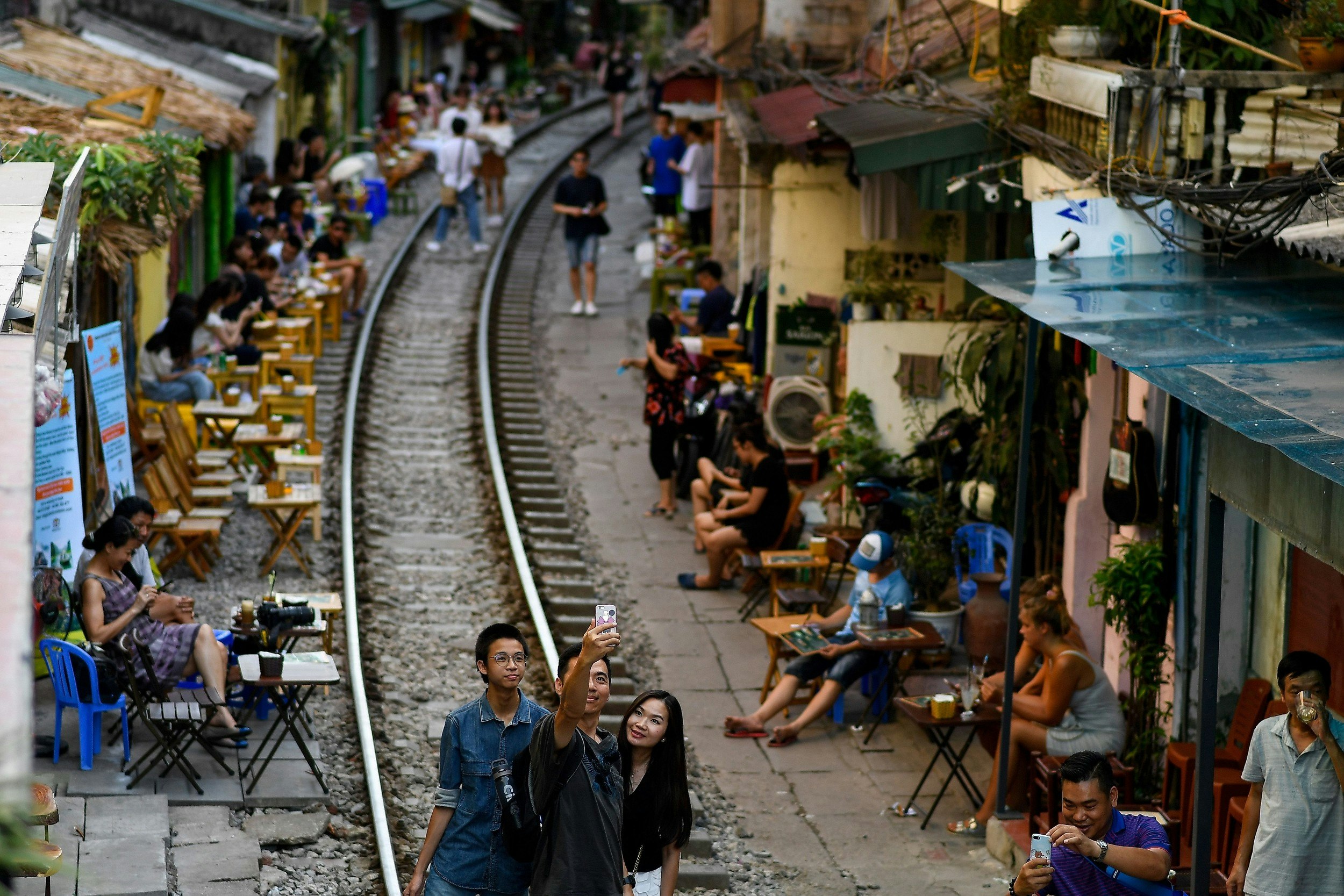 People on the railway track in Hanoi's popular Train Street 