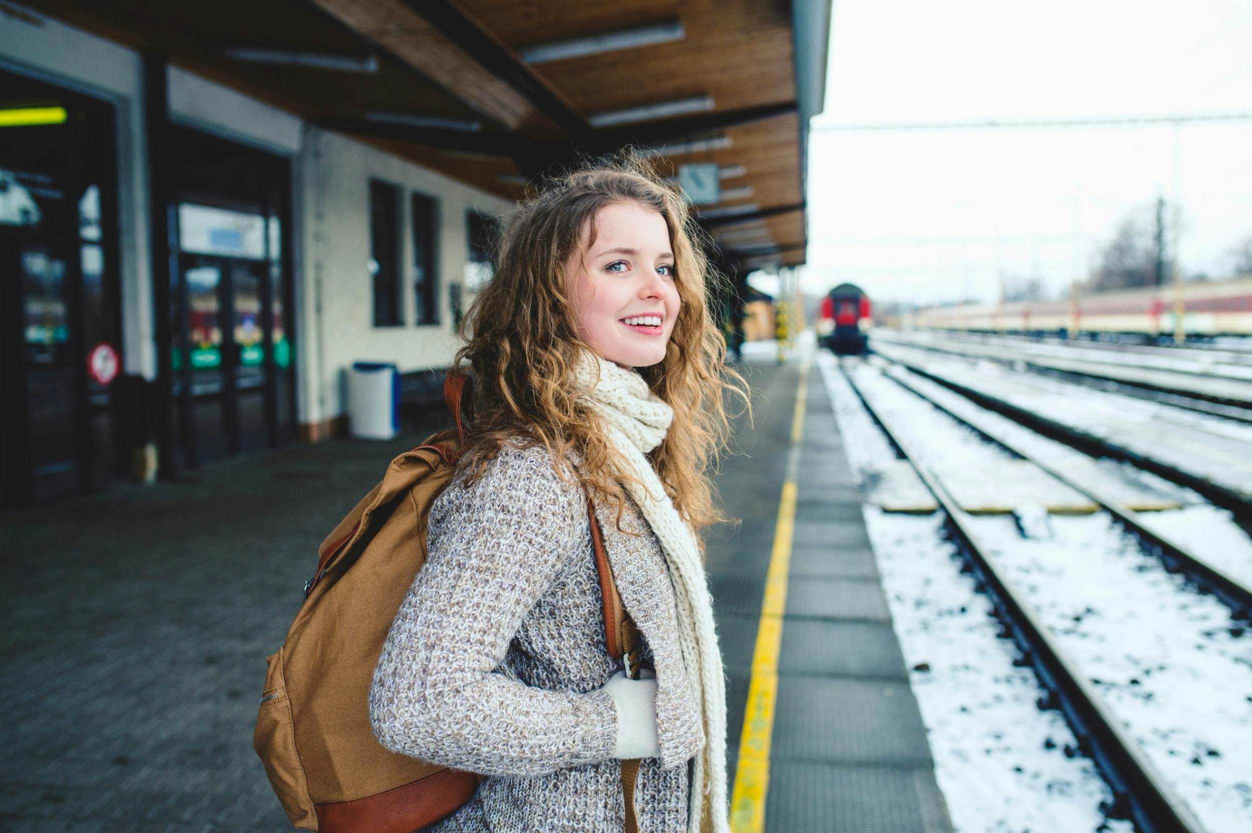 Smiling teenage girl on station platform