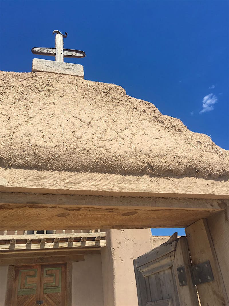 Adobe covers a wooden chapel along the High Road to Taos