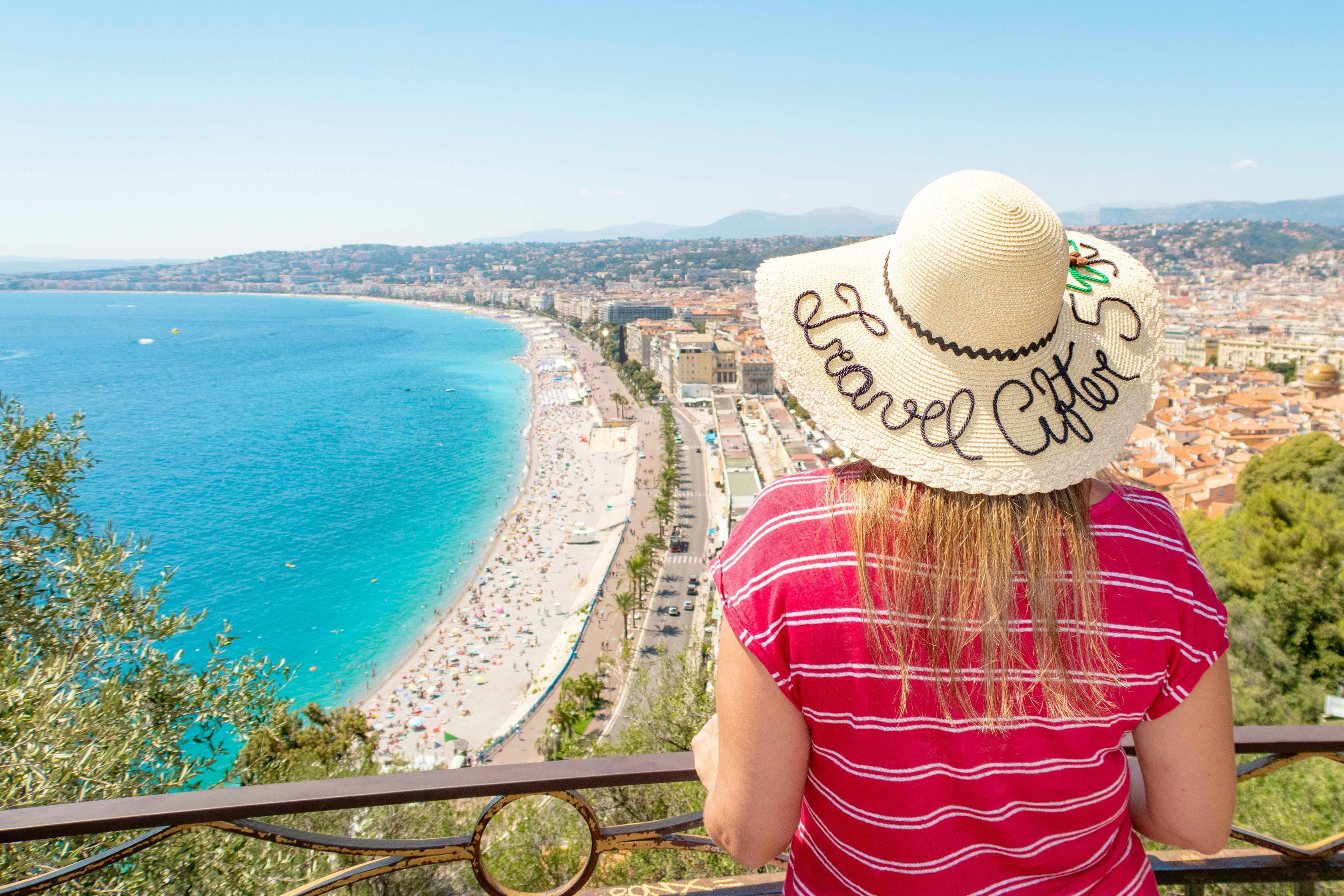 A woman overlooks the beach at Nice on a sunny day