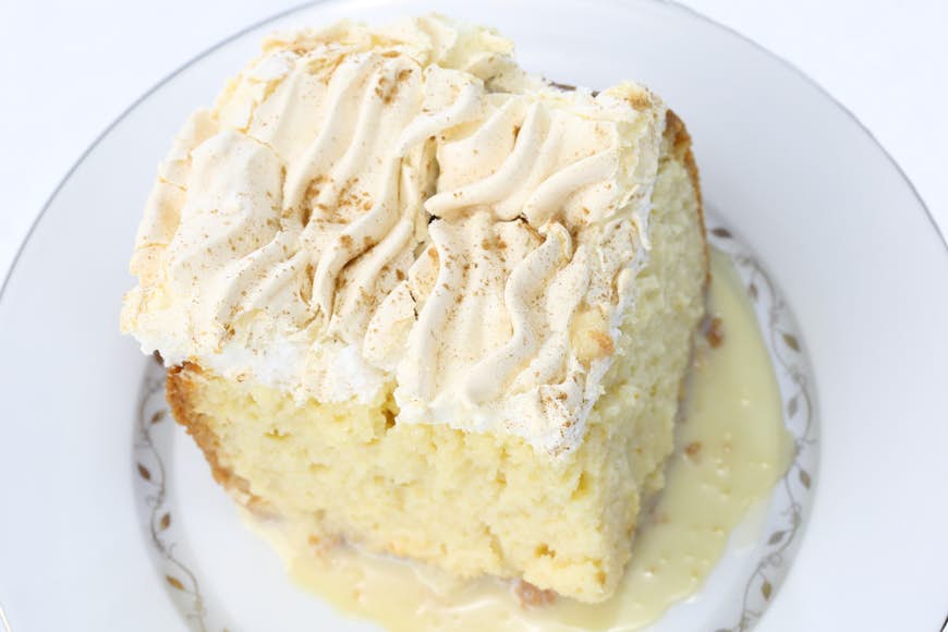 Close up a of a whip-cream covered cake on a plate