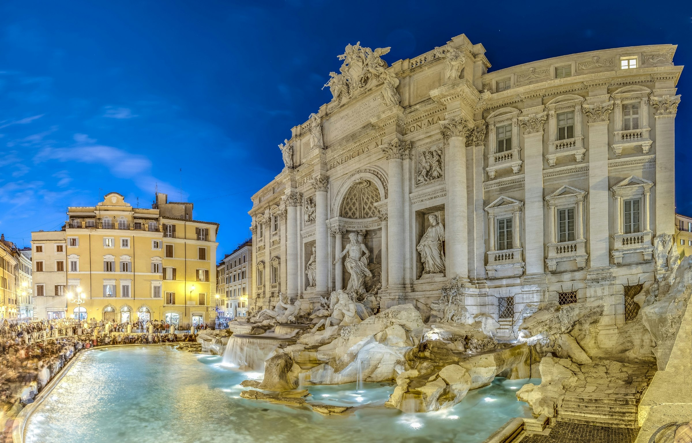 Trevi Fountain in shadow with crowds around the perimeter