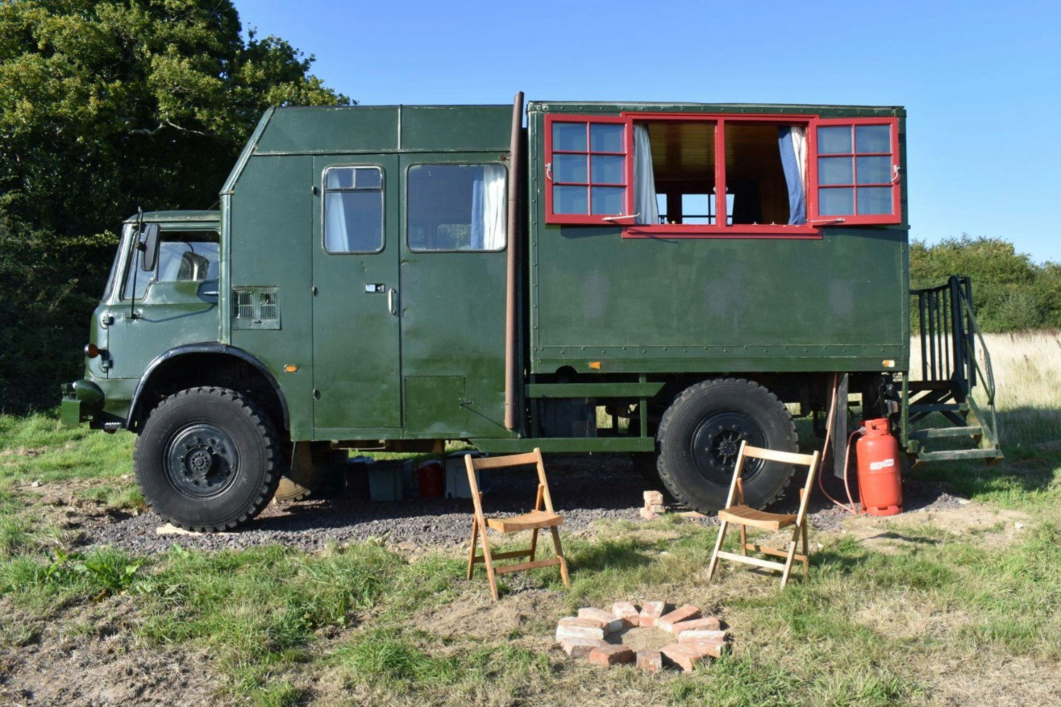 A converted vintage army lorry in field