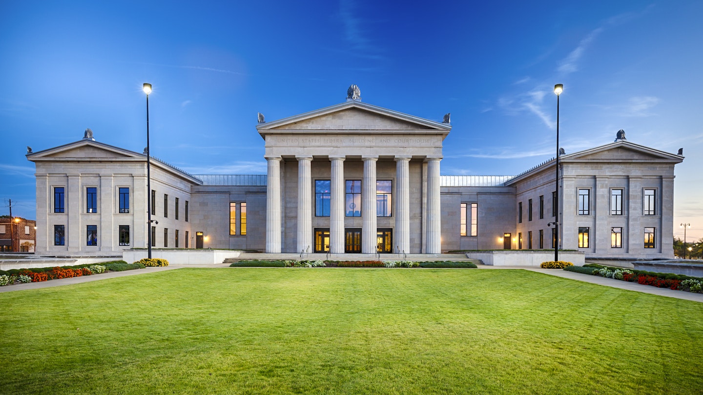Exterior view of pillared and stone structures of the Alabama Federal Building and Courthouse