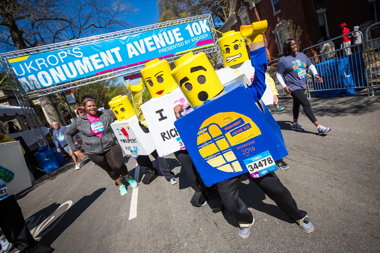A group of people dressed as legos cross the finish line of a 10K race