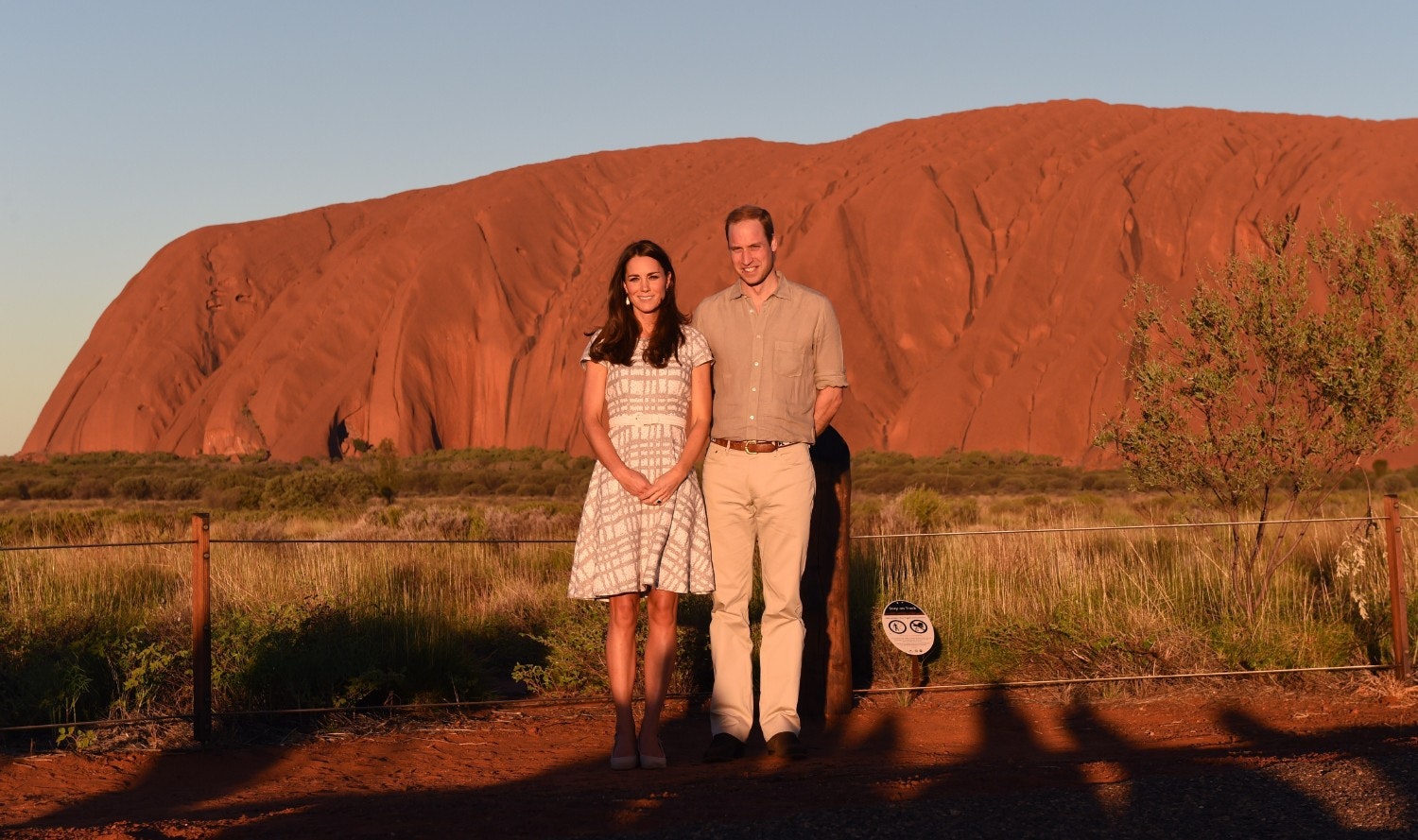 Britain's Prince William and his wife Catherine stand in front of Uluru 
