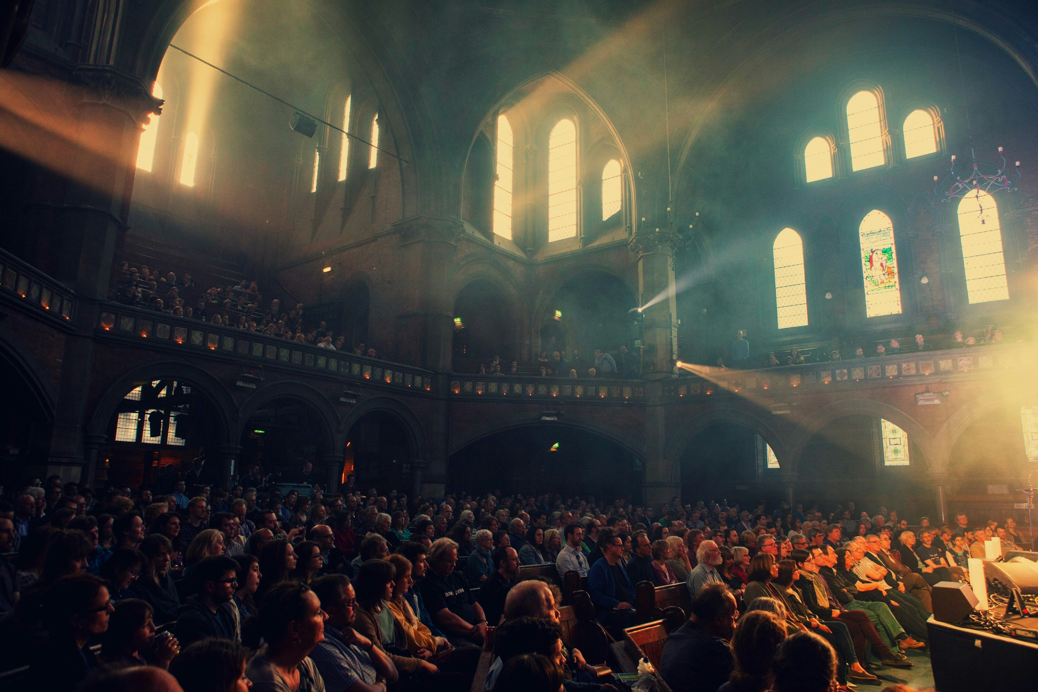 The audience at Union Chapel, a London music venue that is also a working church with stained glass windows.