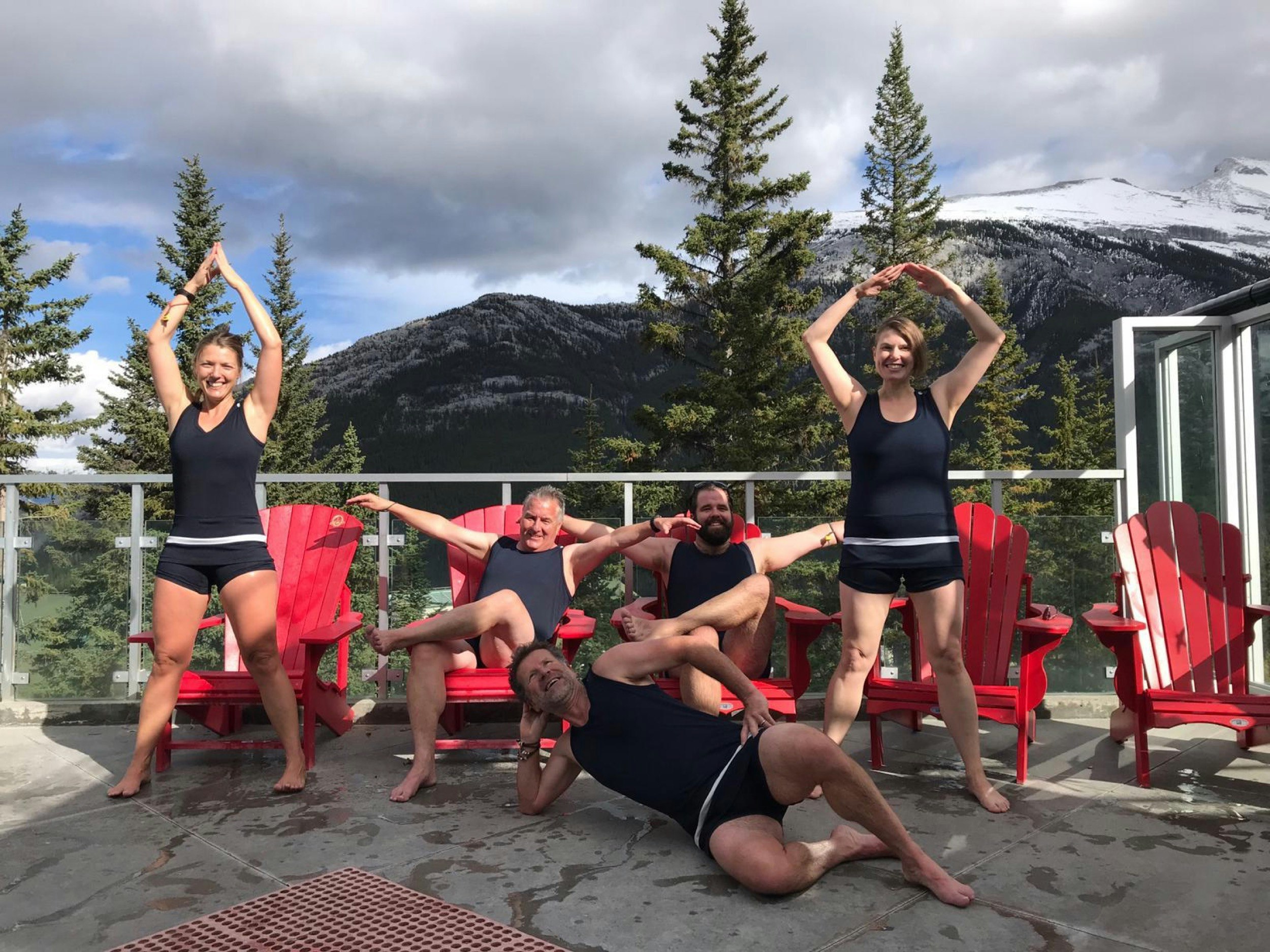 People make crazy poses next to a hot spring while wearing silly bathing suits during winter at Banff and Lake Louise
