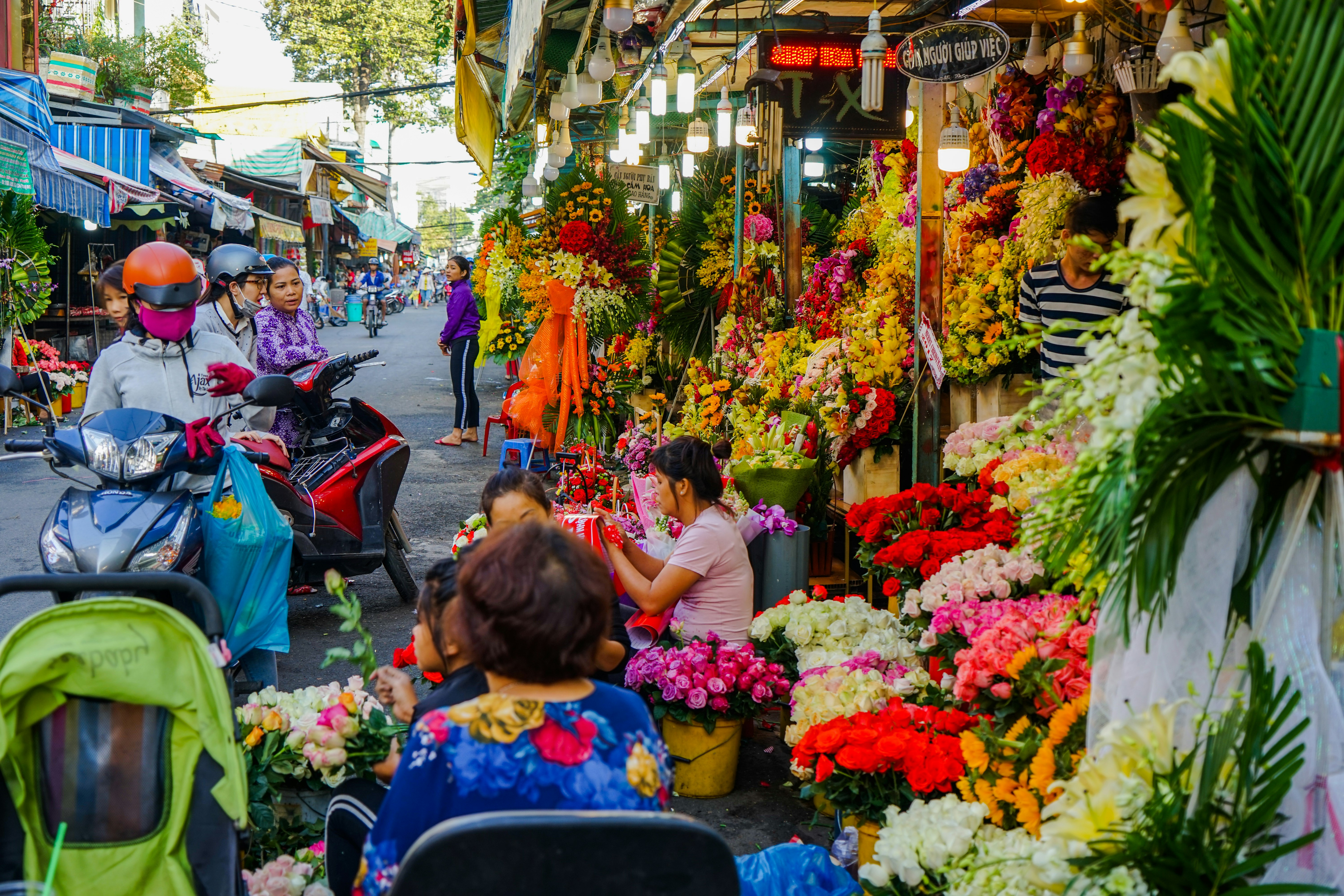 Brighly coloured flower fill a market. 