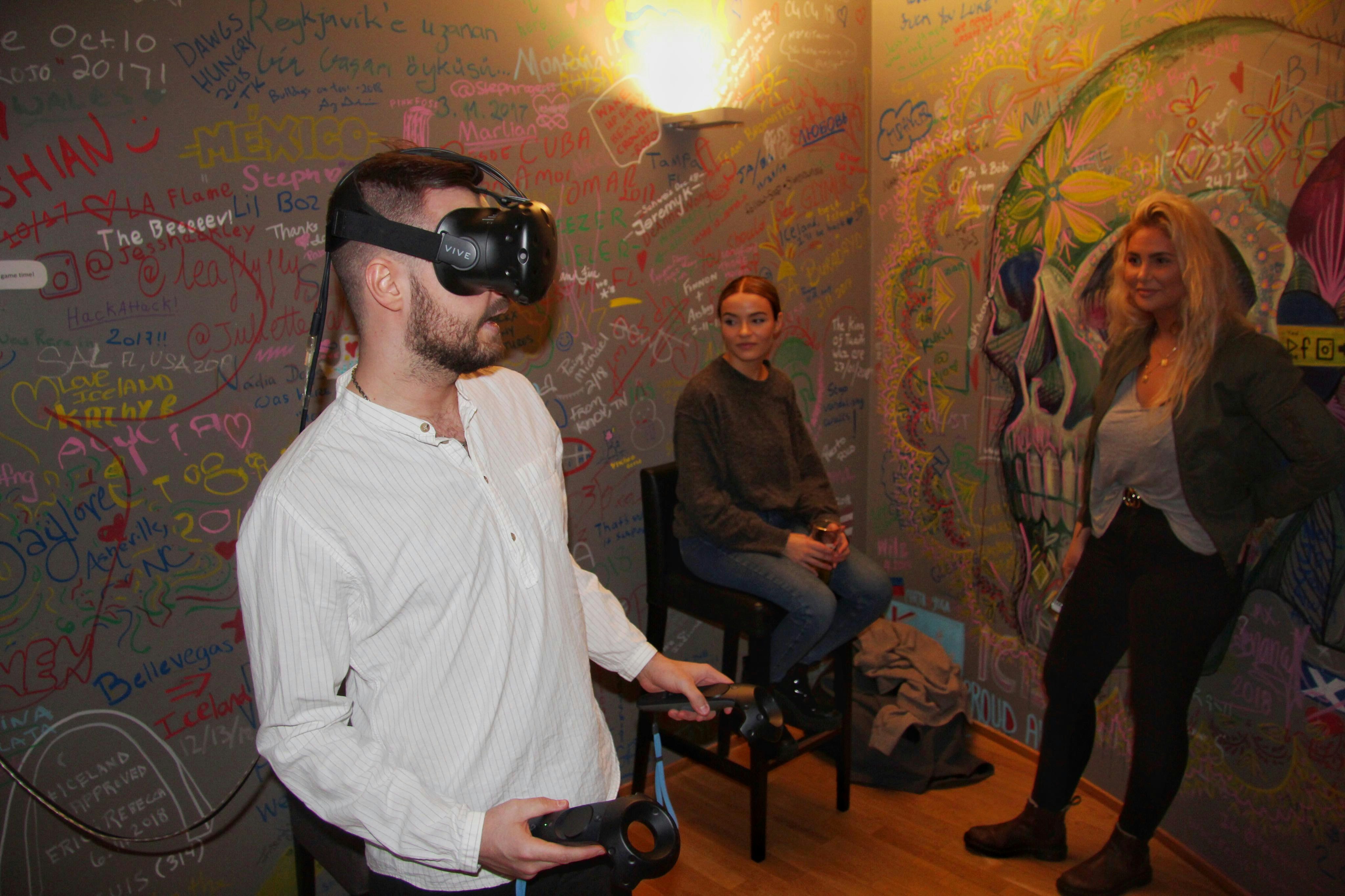 Guests at Galaxy Pod Hostel in Iceland play with a VR headset