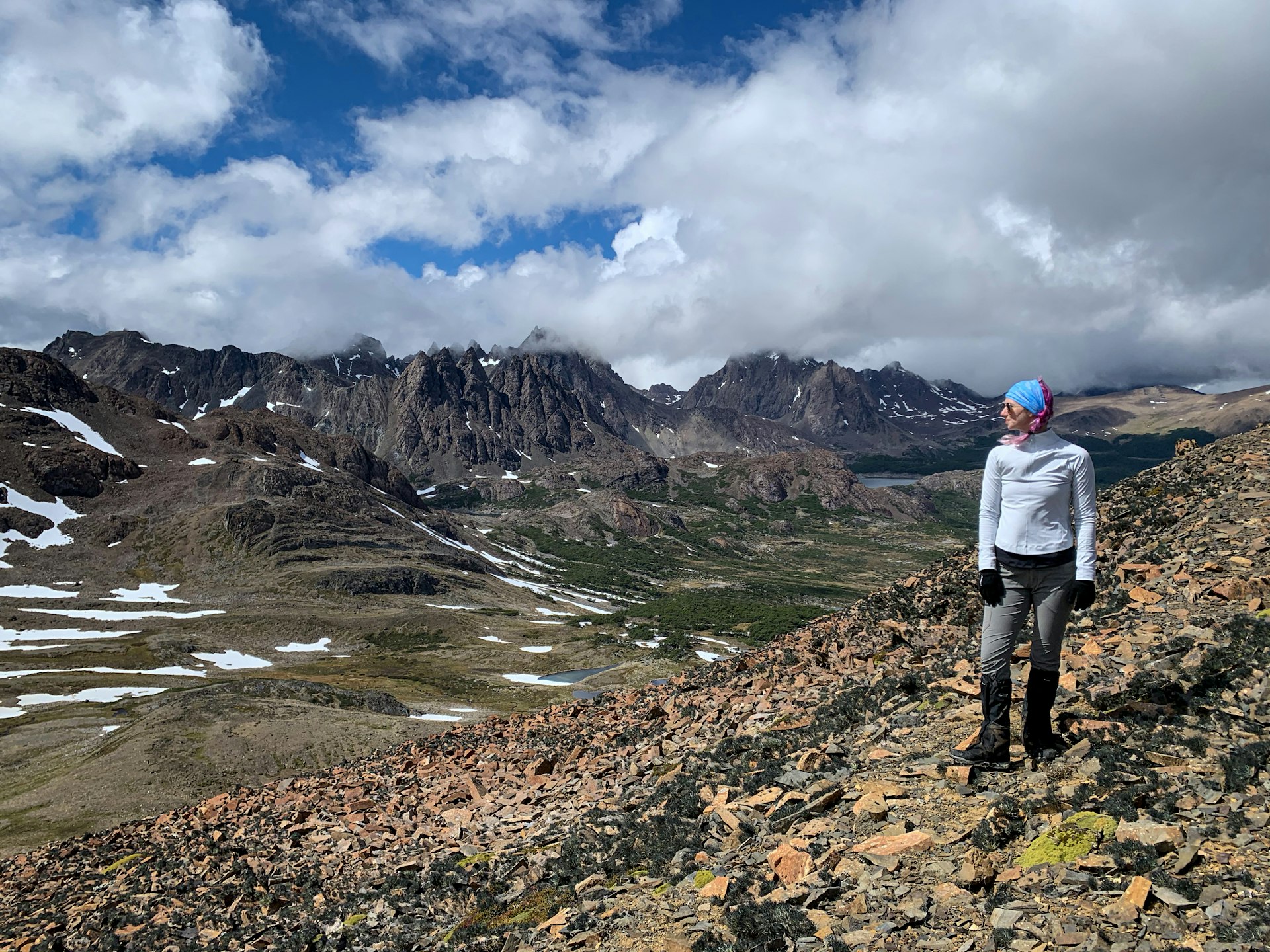 Bailey stands looking out over a rugged, almost barren landscape from Paso Ventarron on the Dientes trail.