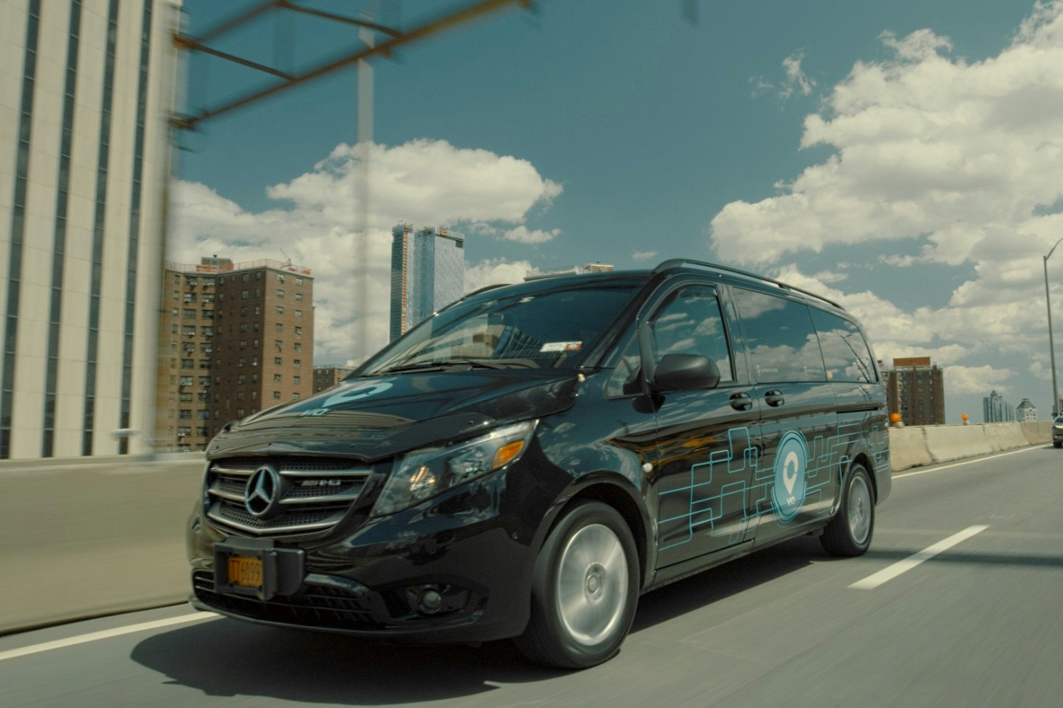 A Via ride-share car driving on a bridge