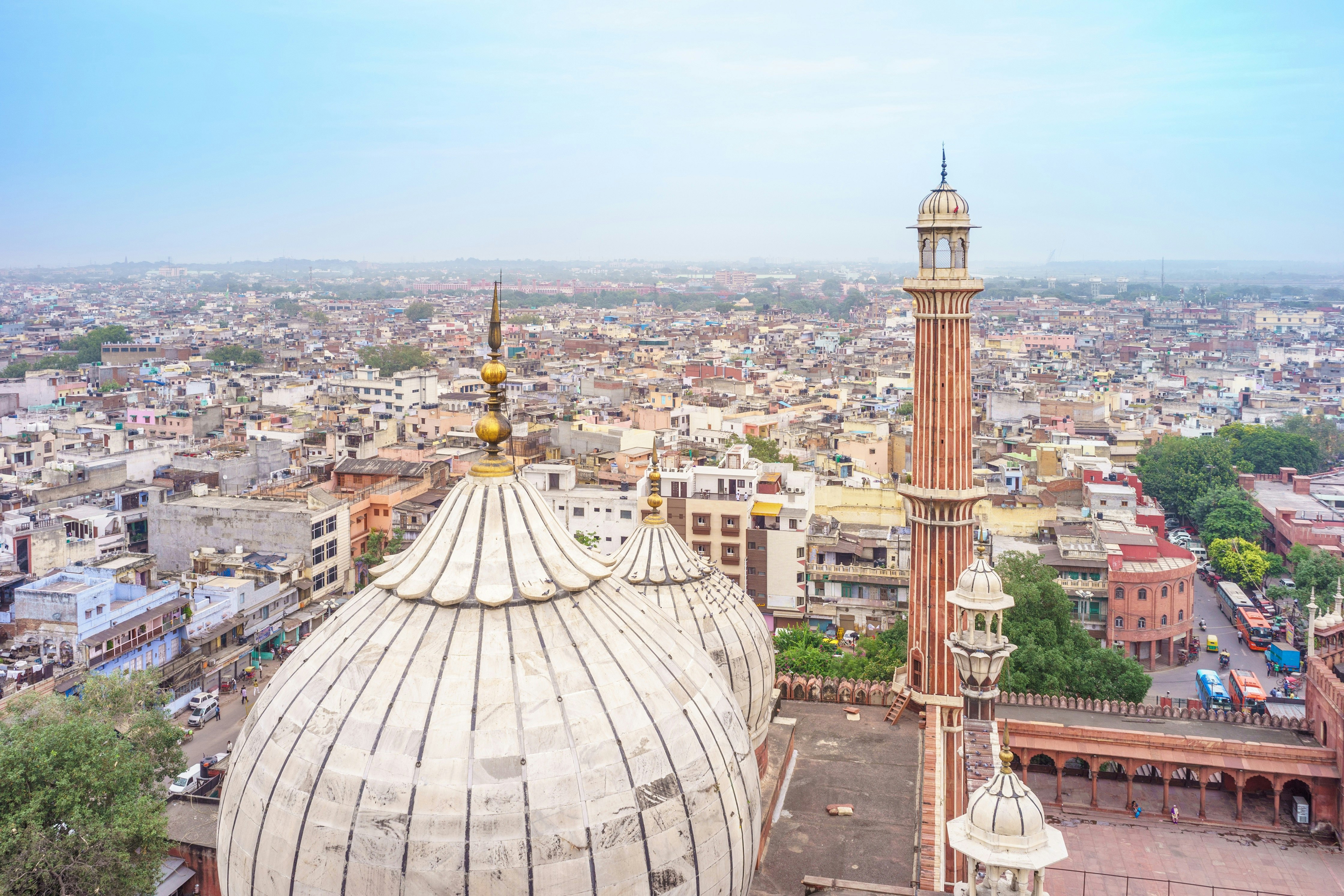 A view out from the minaret of Jama Masjid mosque in Old Delhi. From the vantage point the mosque's domed roof is visible, as are the hundreds of rooftops of the buildings that make up Old Delhi.
