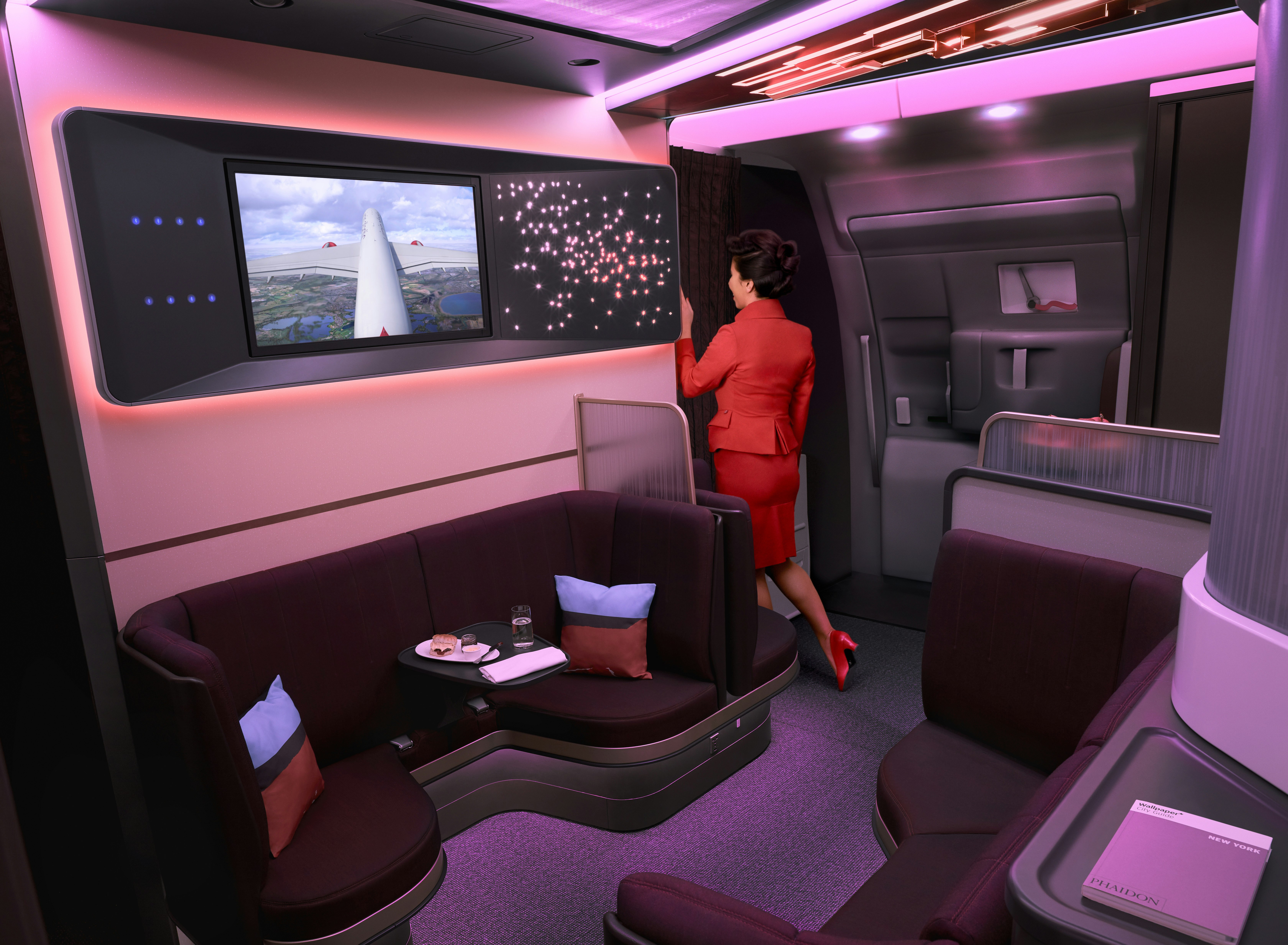 A screen and lounge area on a Virgin flight