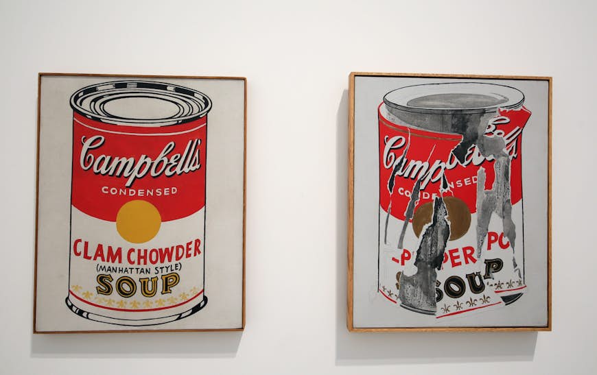 Images of Campbell's Soup Cans, one pristine and one shredded, are displayed at a museum in Los Angeles; Warhol in the US