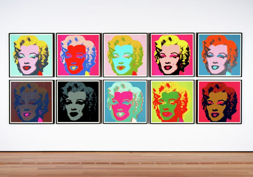A row of colorful screen prints featuring Marilyn Monroe; Warhol in America