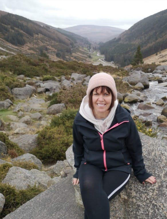 A woman sitting on a rock in the Wicklow Hills