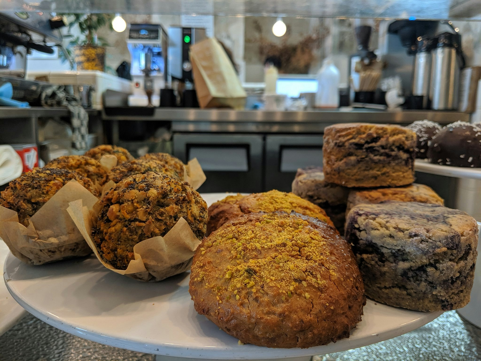 Close-up of sweet and savoury cakes and muffins on a white cake stand.