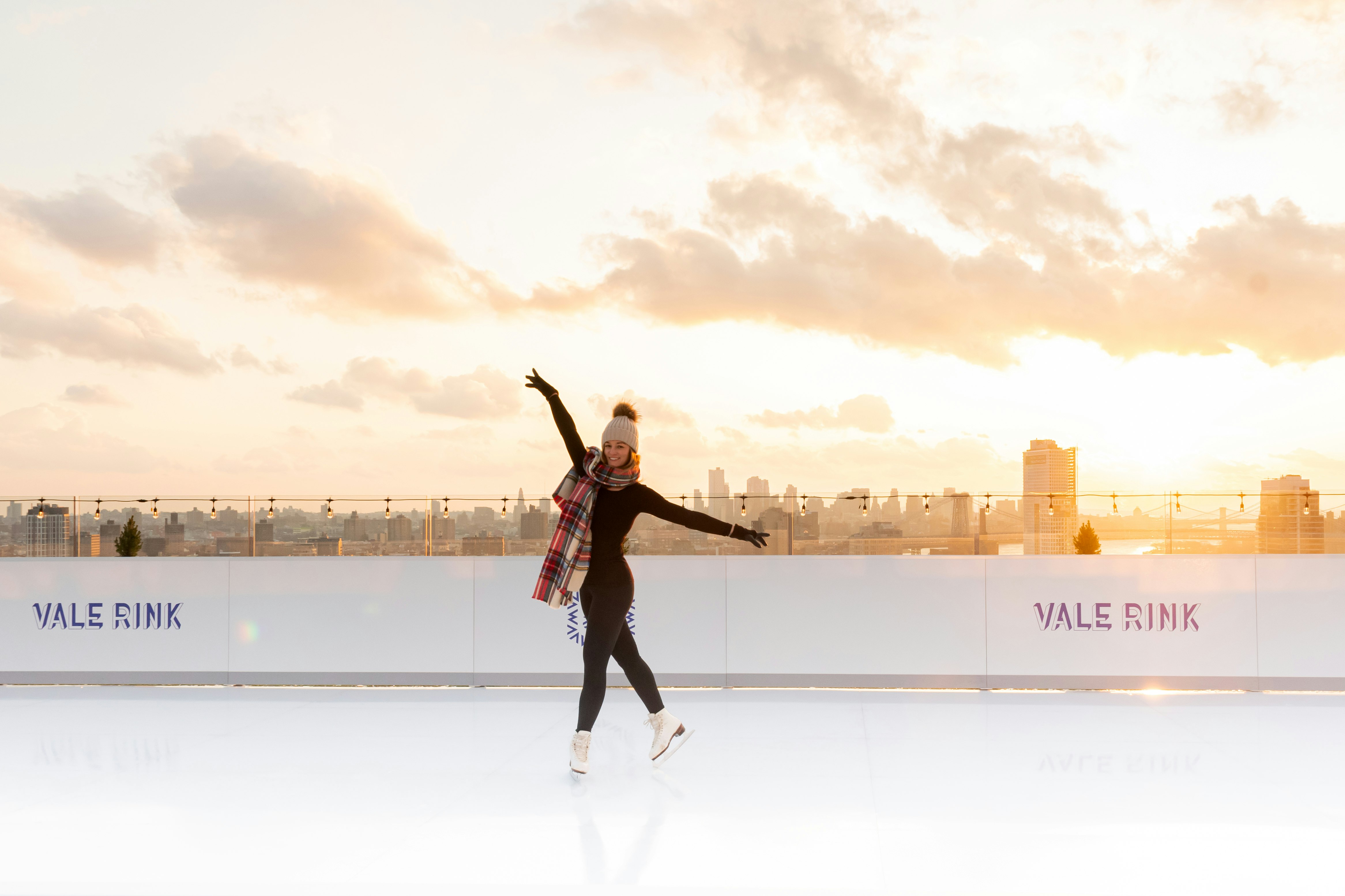 A woman skating above NYC at William Vale Rink