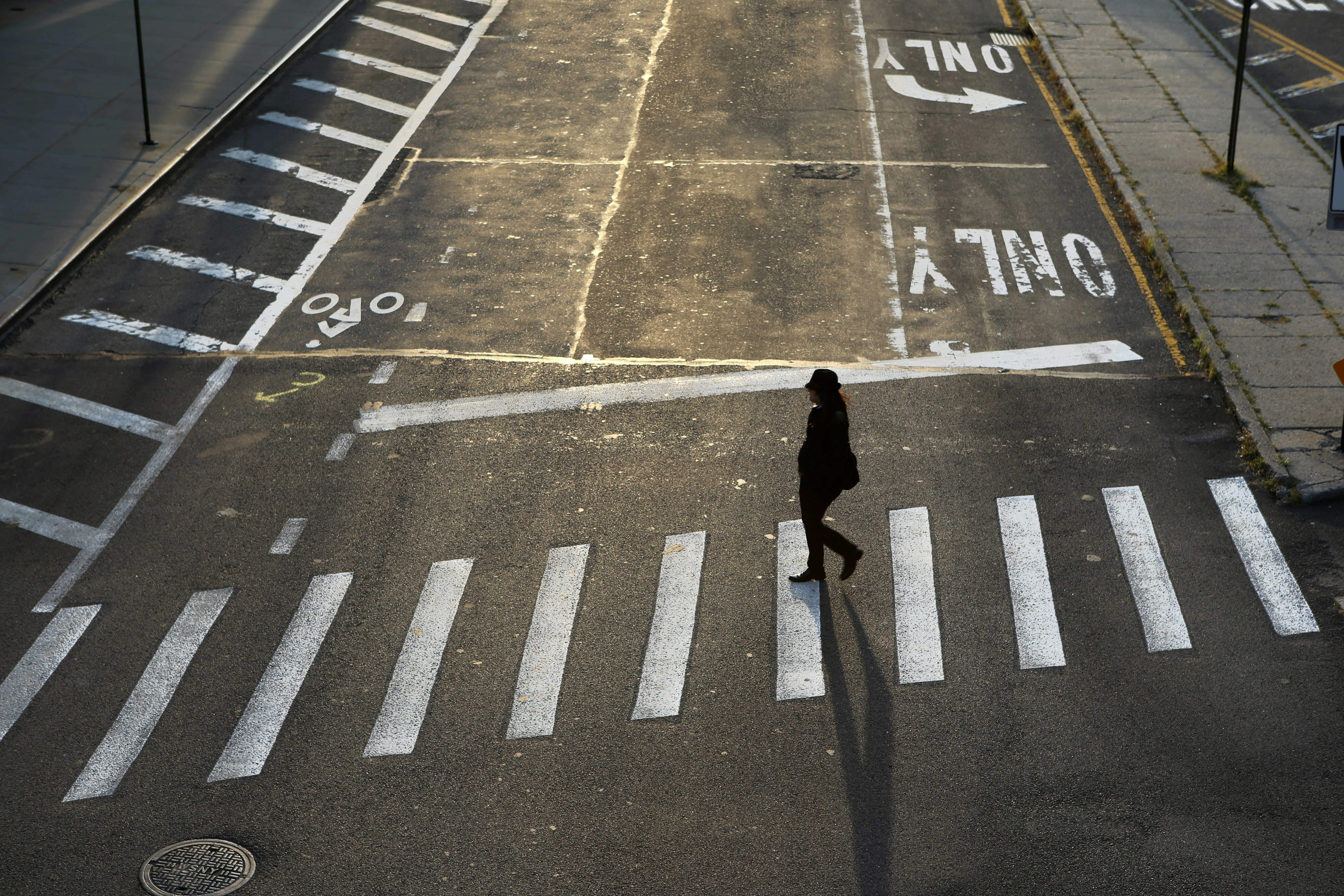 Woman crossing empty street in Brooklyn's Dumbo neighborhood