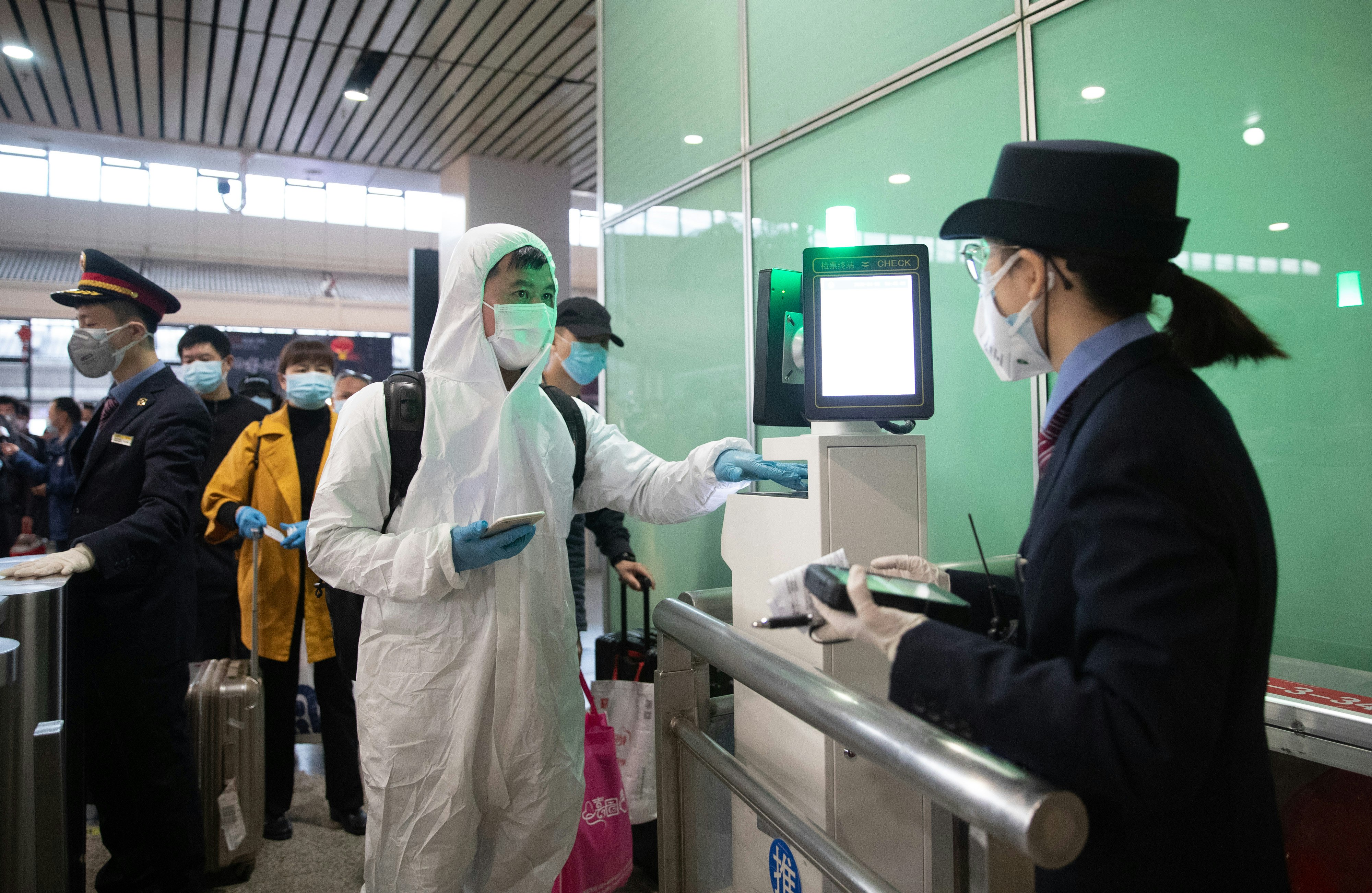 Passengers on the g413 high speed rail pass through the entrance