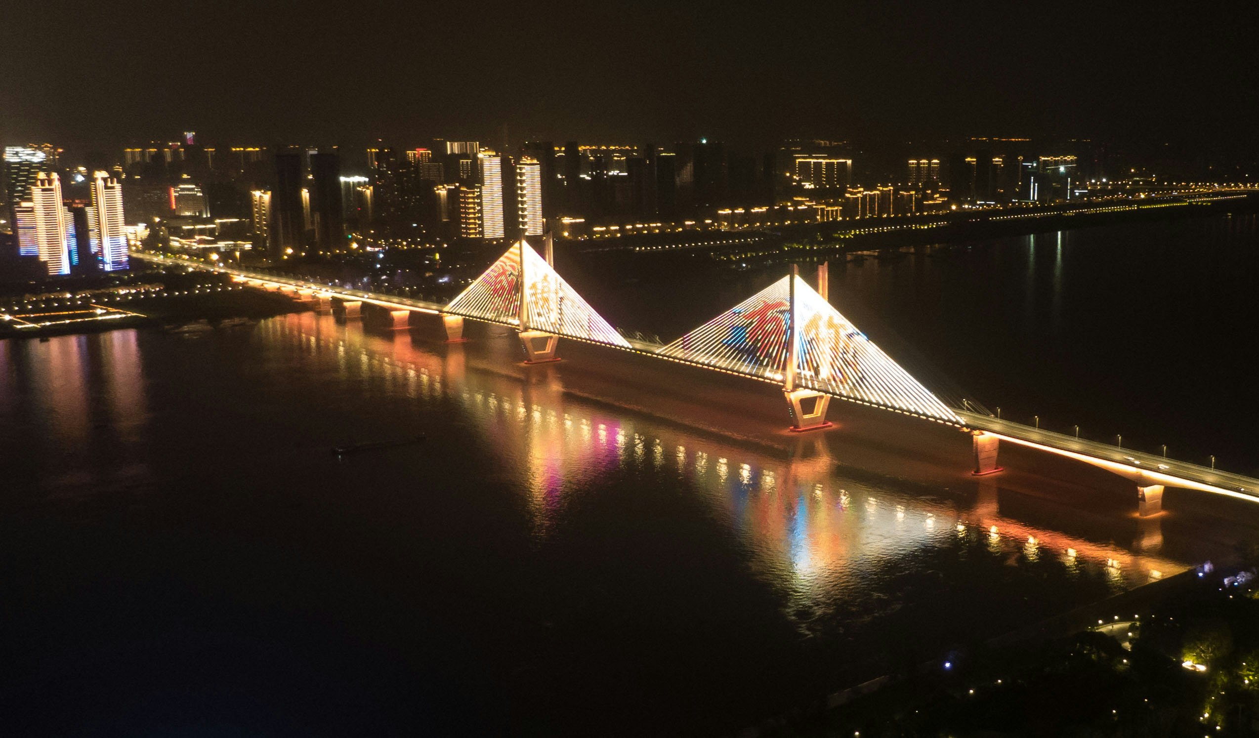 Aerial photo taken on April 8, 2020 shows an illuminated bridge in Wuhan