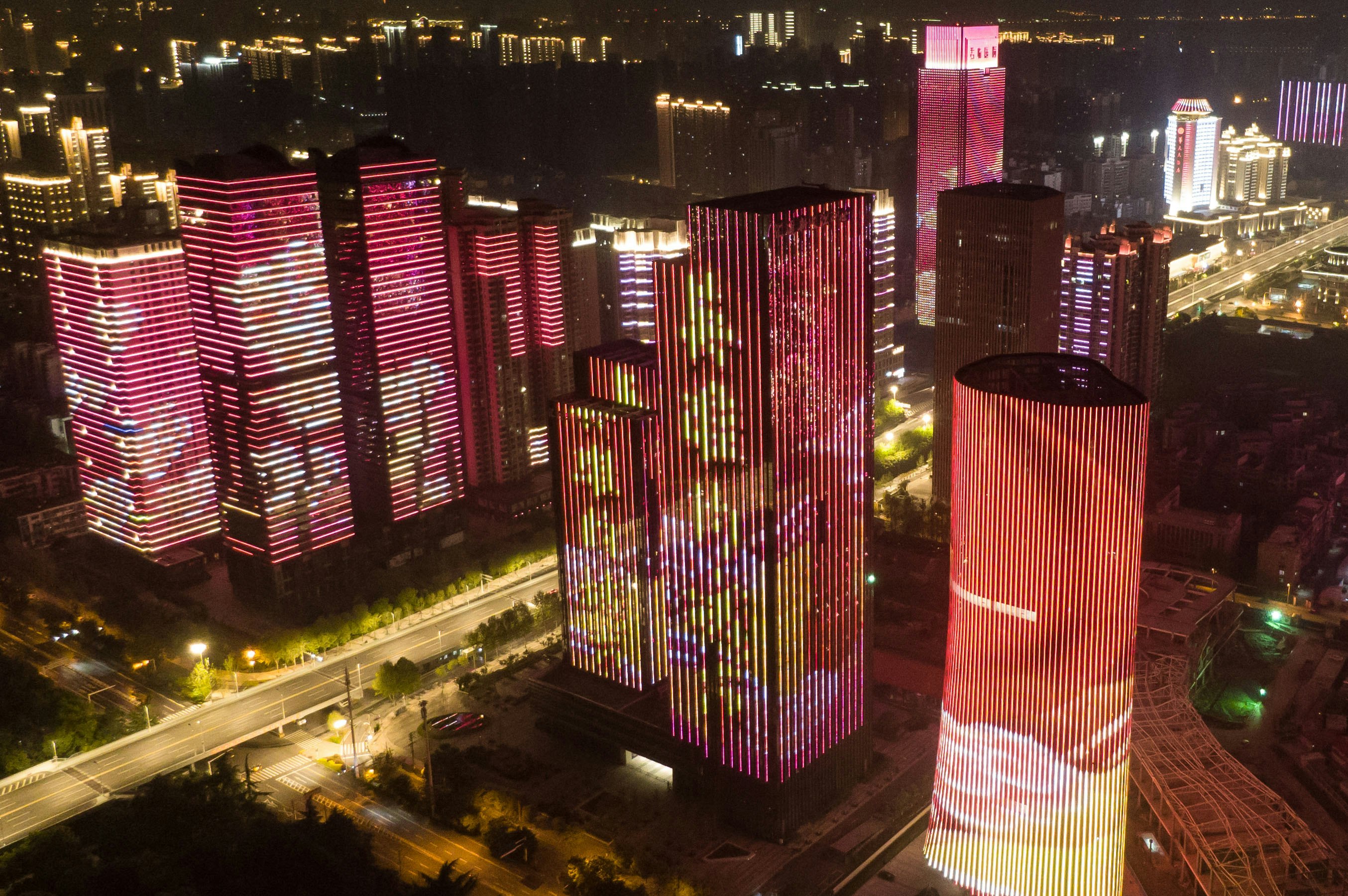 Wuhan skyscrapers illuminated with images of frontline workers