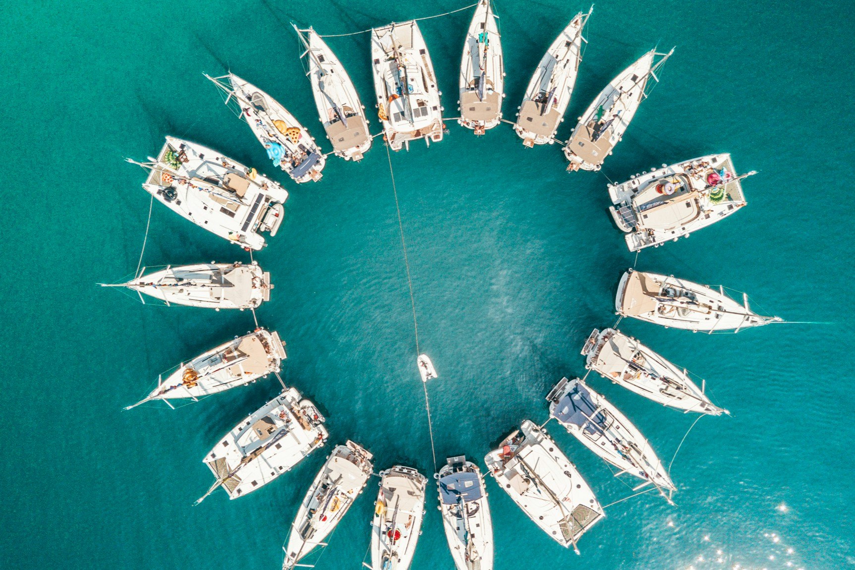 A series of yachts in the water arranged in a circular shape
