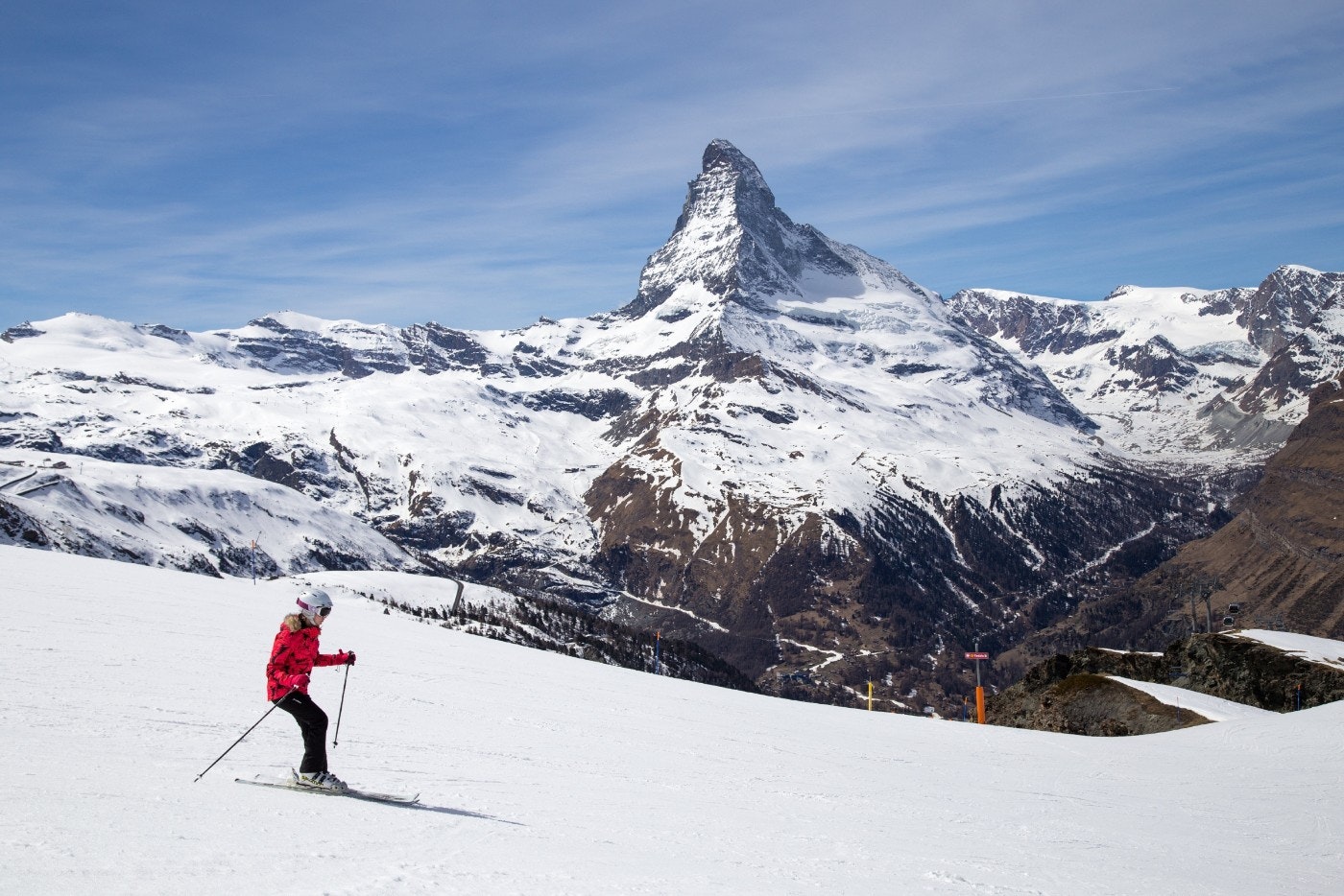 A woman skiing in front of the famous Matterhorn in Zermatt