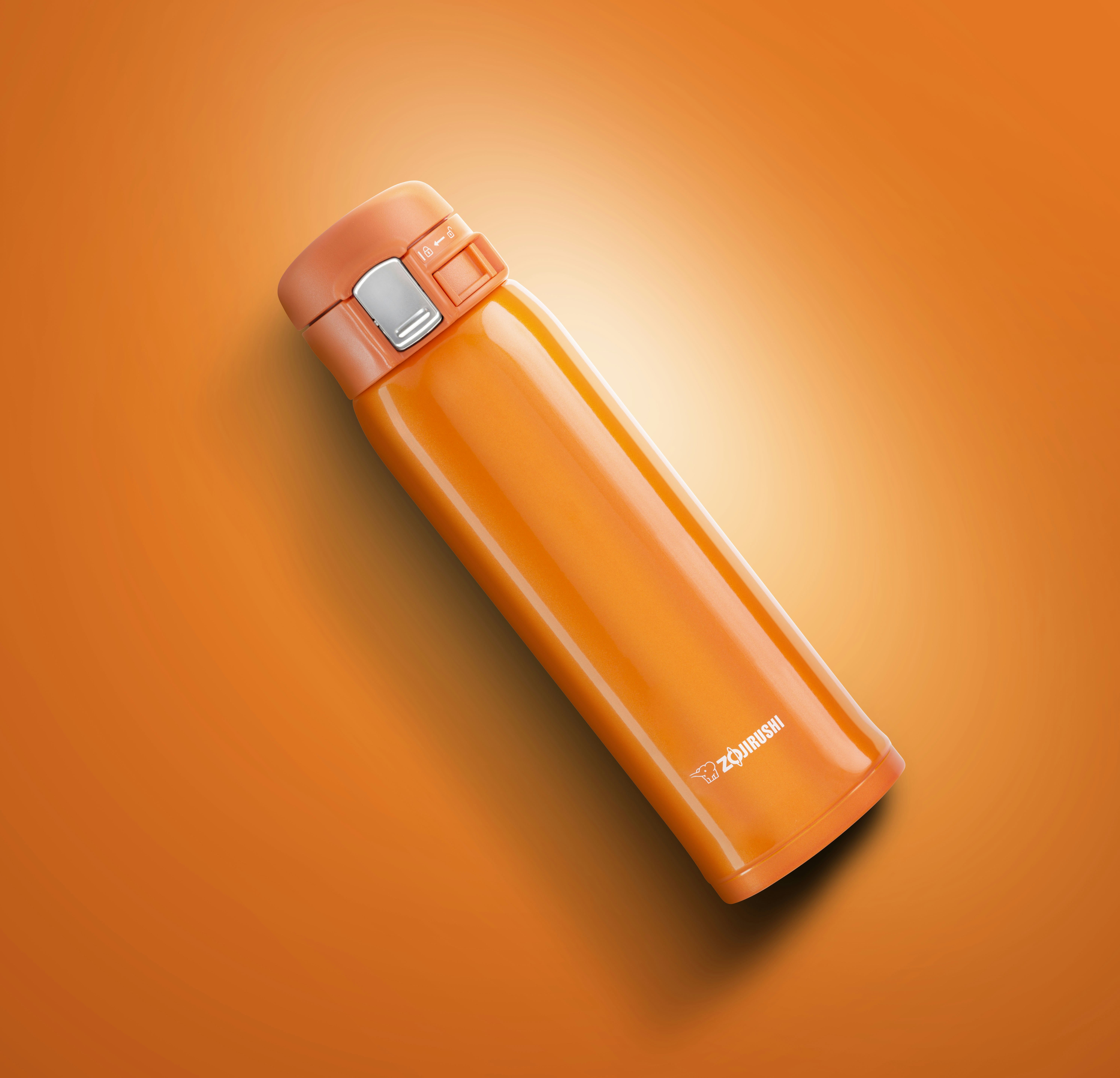 Orange Zojirushi thermos on an orange background