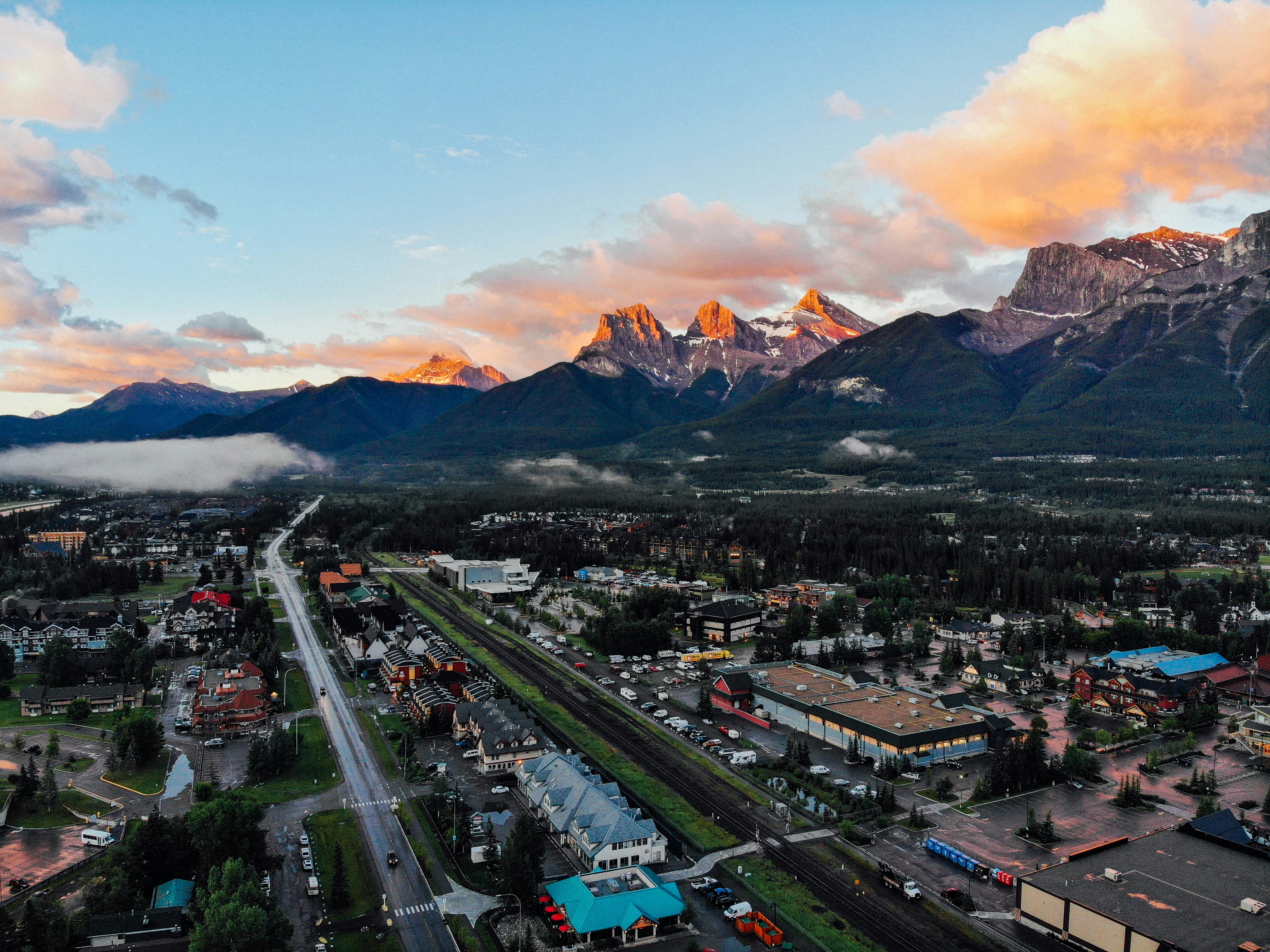 An aerial view of a town, with mountains in the background