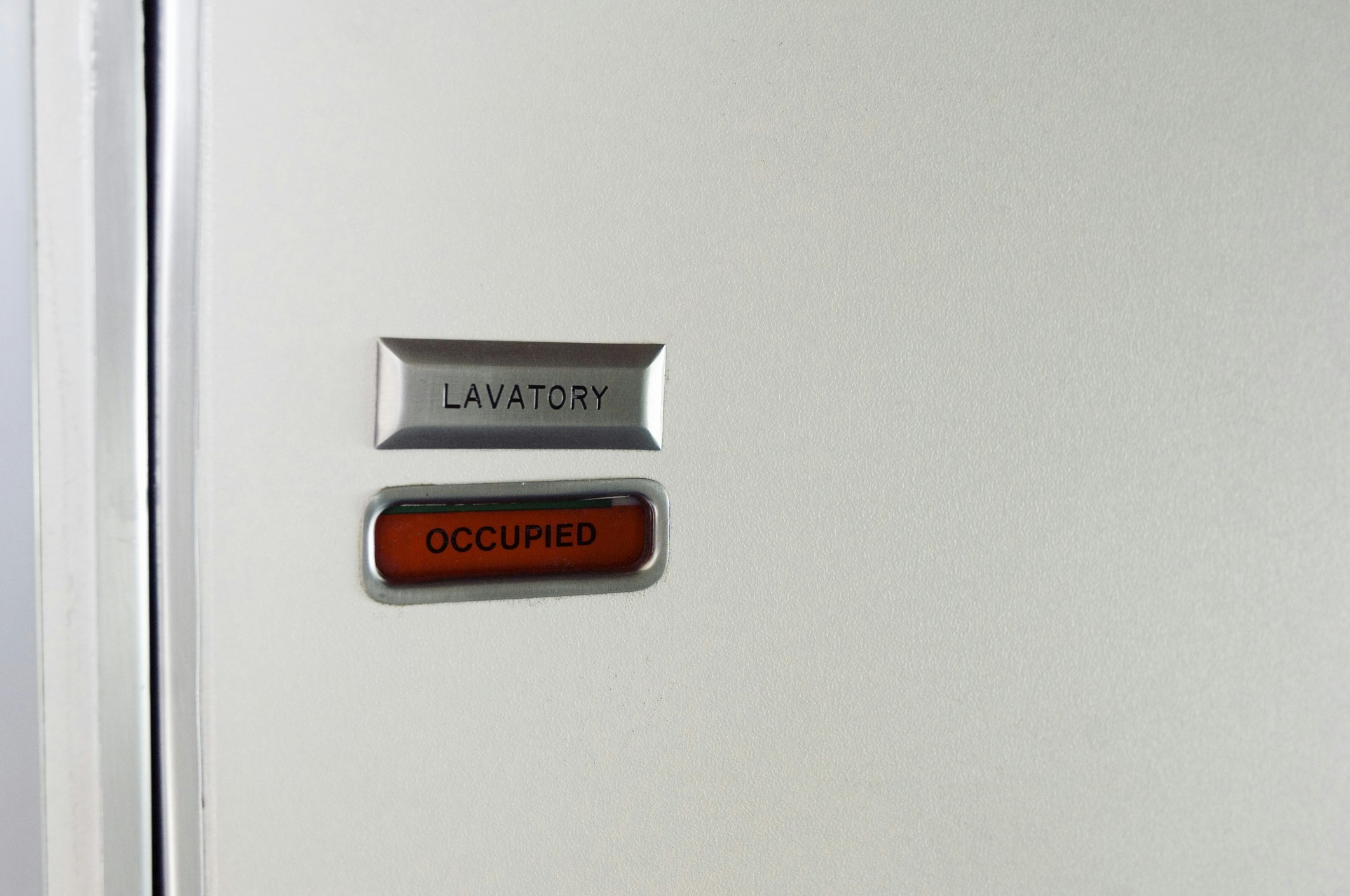 the occuped sign of an airplane toilet.  