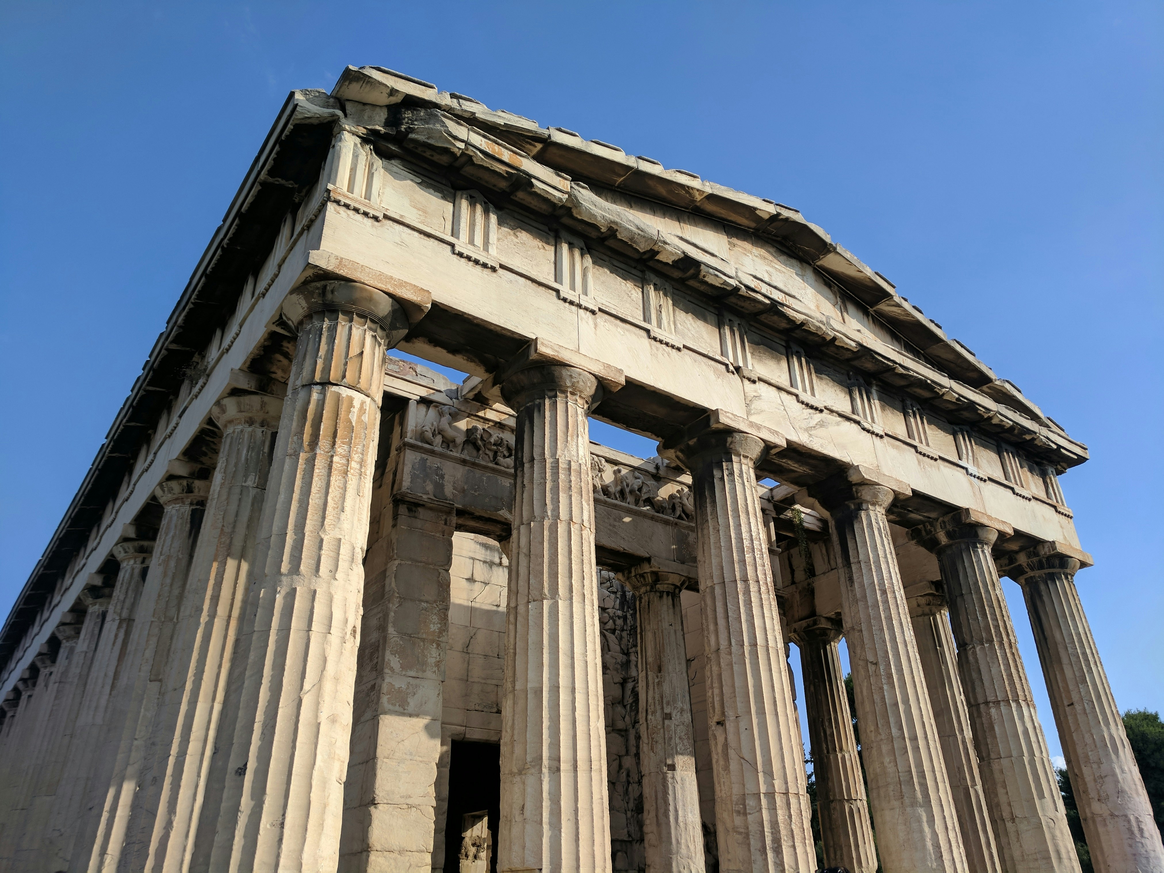 An exterior shot looking up at the columns and inner roofline friezes of the Parthenon shows how sculptures once decorated almost every surface of the structure 